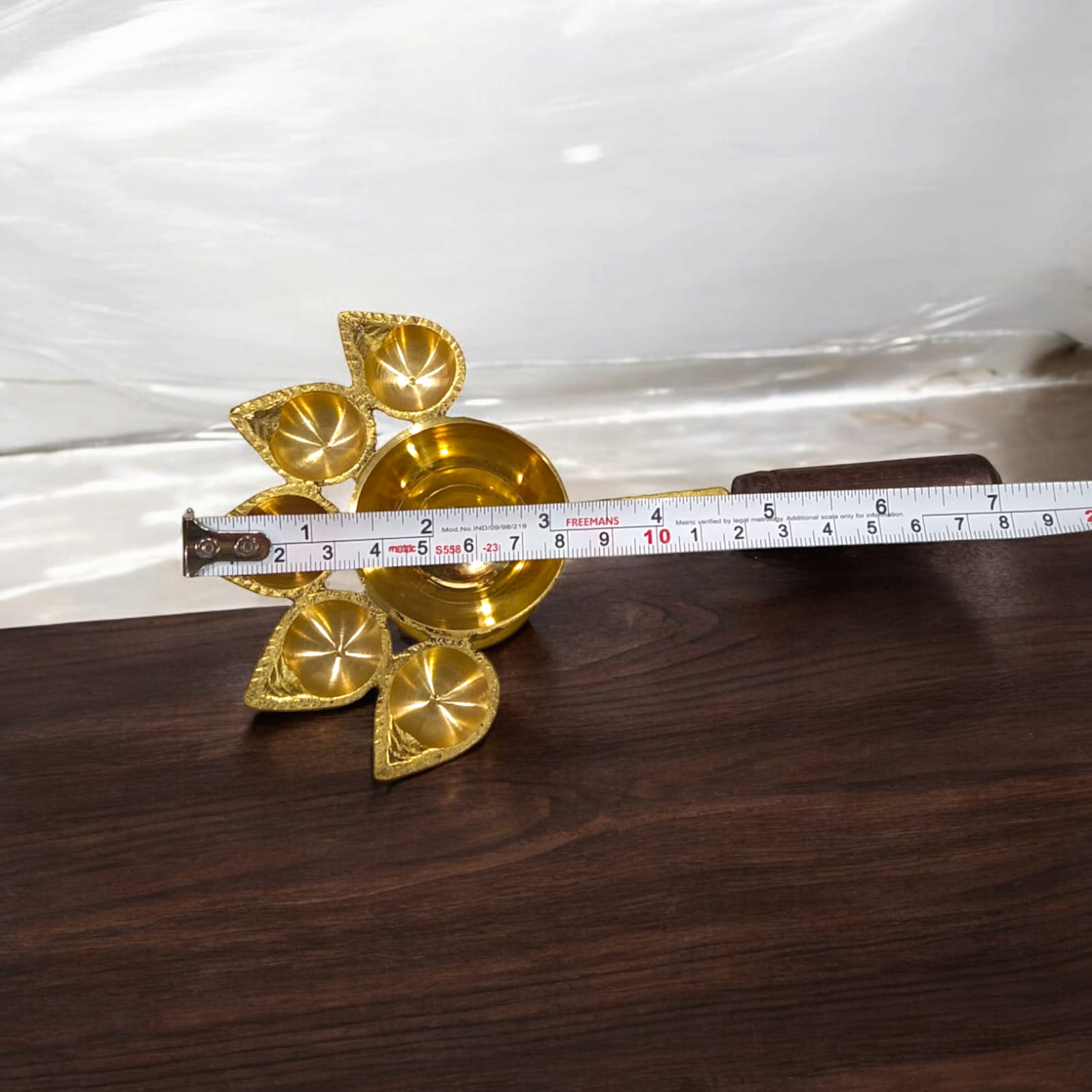 5-face brass Panch Mukhi Jyot with handle, ideal for Aarti, featuring an elegant finish, available at Timeshopee.q