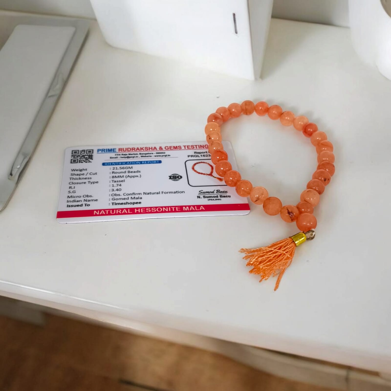 A Hessonite (Gomed) Mala with 27+1 lab-certified deep red gemstone beads, each 8MM in size, designed for meditation, focus, and astrological benefits, ideal for travel, office, and car.