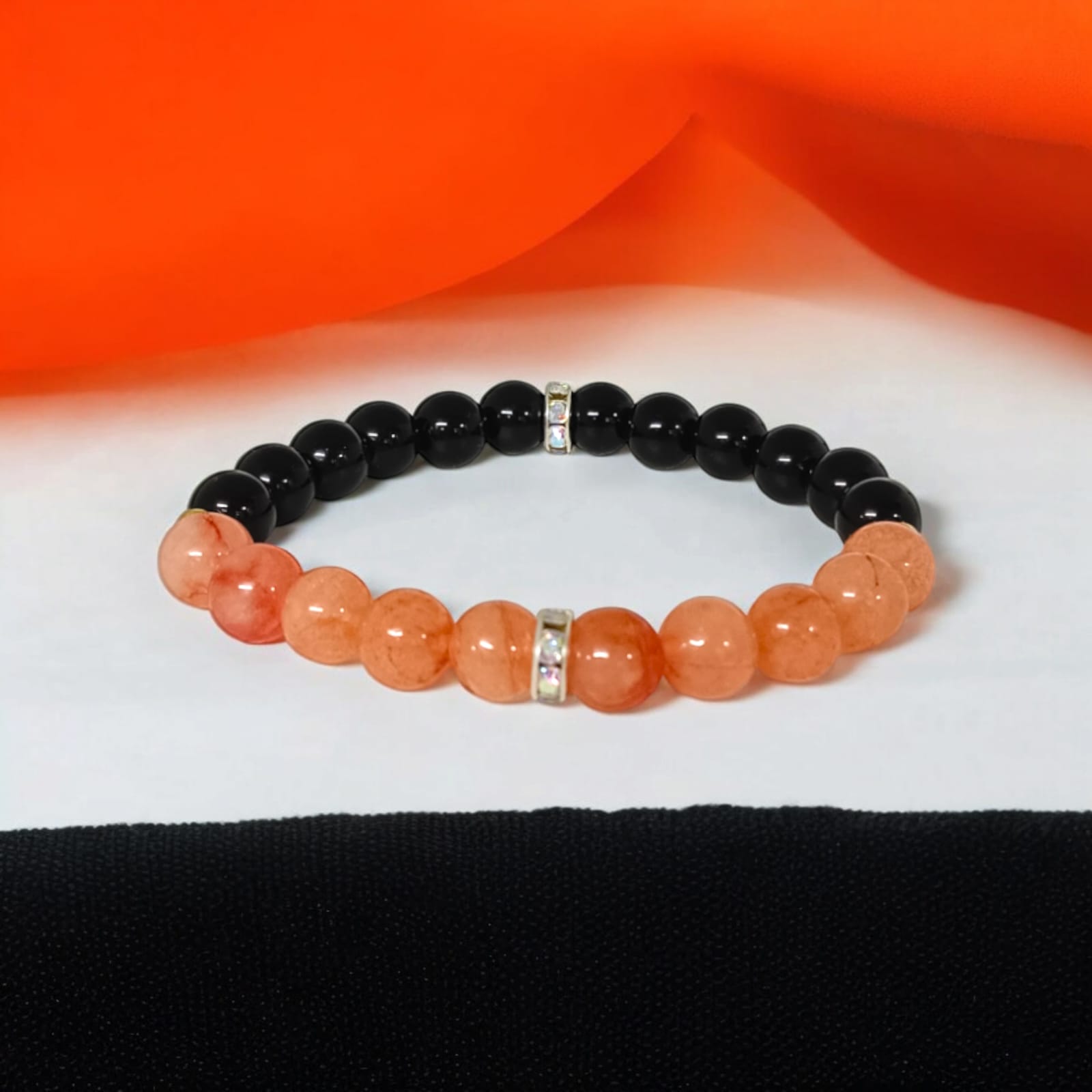 A Hessonite and Black Agate Bracelet with 8MM lab-certified beads, featuring a stretchable design for comfort and spiritual protection.