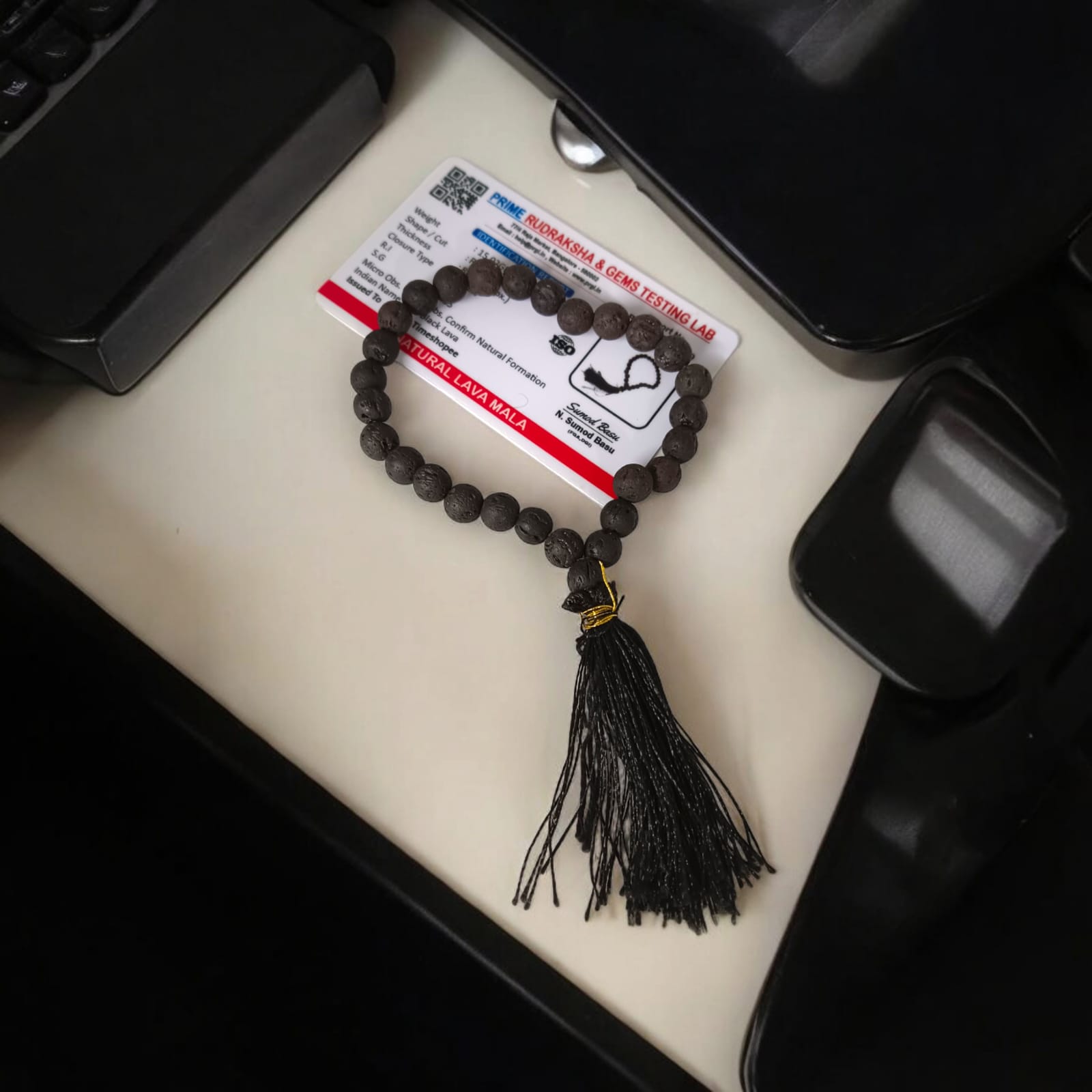 A Natural Lava Mala with 27+1 lab-certified black lava stone beads, each 8MM in size, perfect for grounding energy, meditation, and aromatherapy, suitable for car, office, and travel.