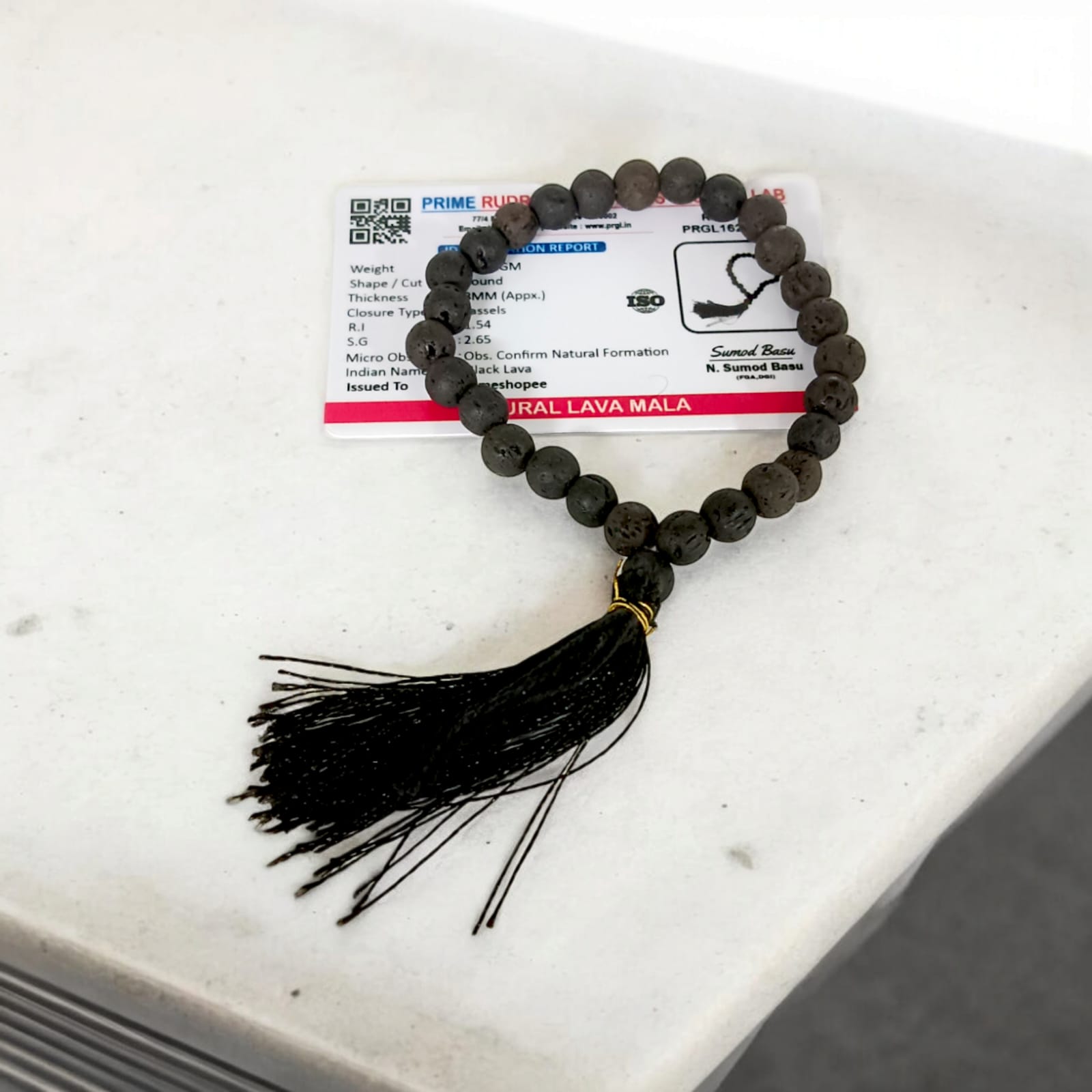 A Natural Lava Mala with 27+1 lab-certified black lava stone beads, each 8MM in size, perfect for grounding energy, meditation, and aromatherapy, suitable for car, office, and travel.