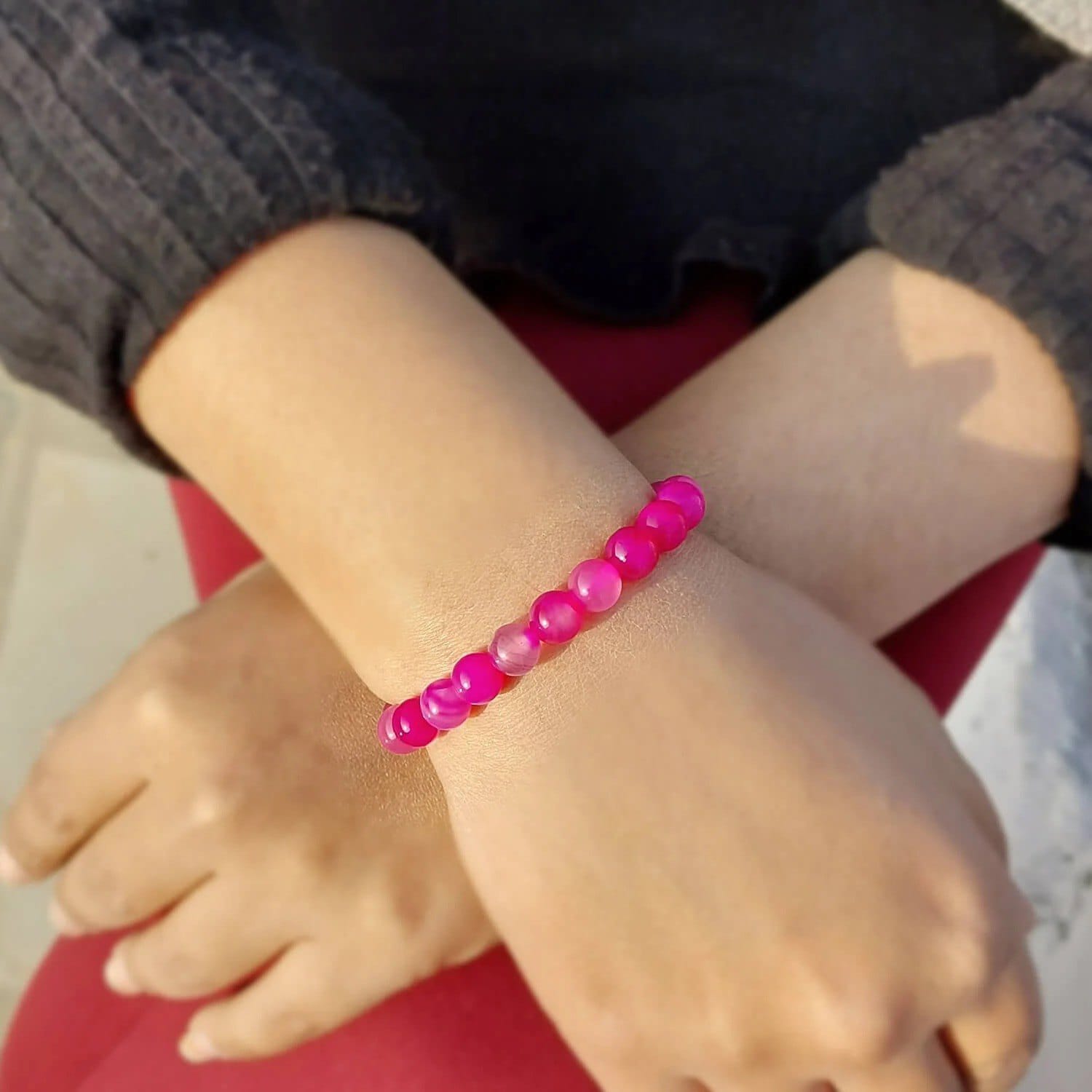 A Pink Agate Bracelet with 8MM lab-certified beads, designed in a stretchable style, offering elegance and spiritual balance.