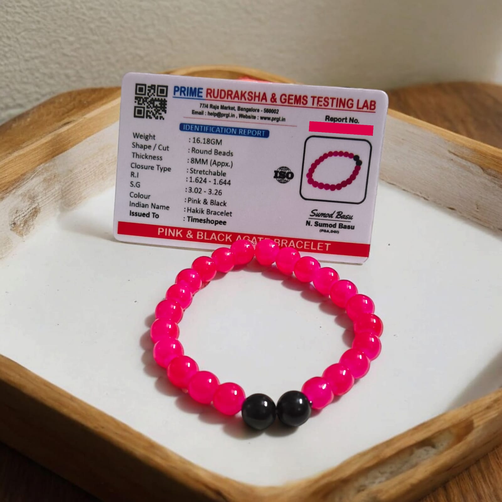 A Pink & Black Agate Bracelet with 8MM lab-certified beads, featuring a stretchable design, ideal for meditation and daily wear.