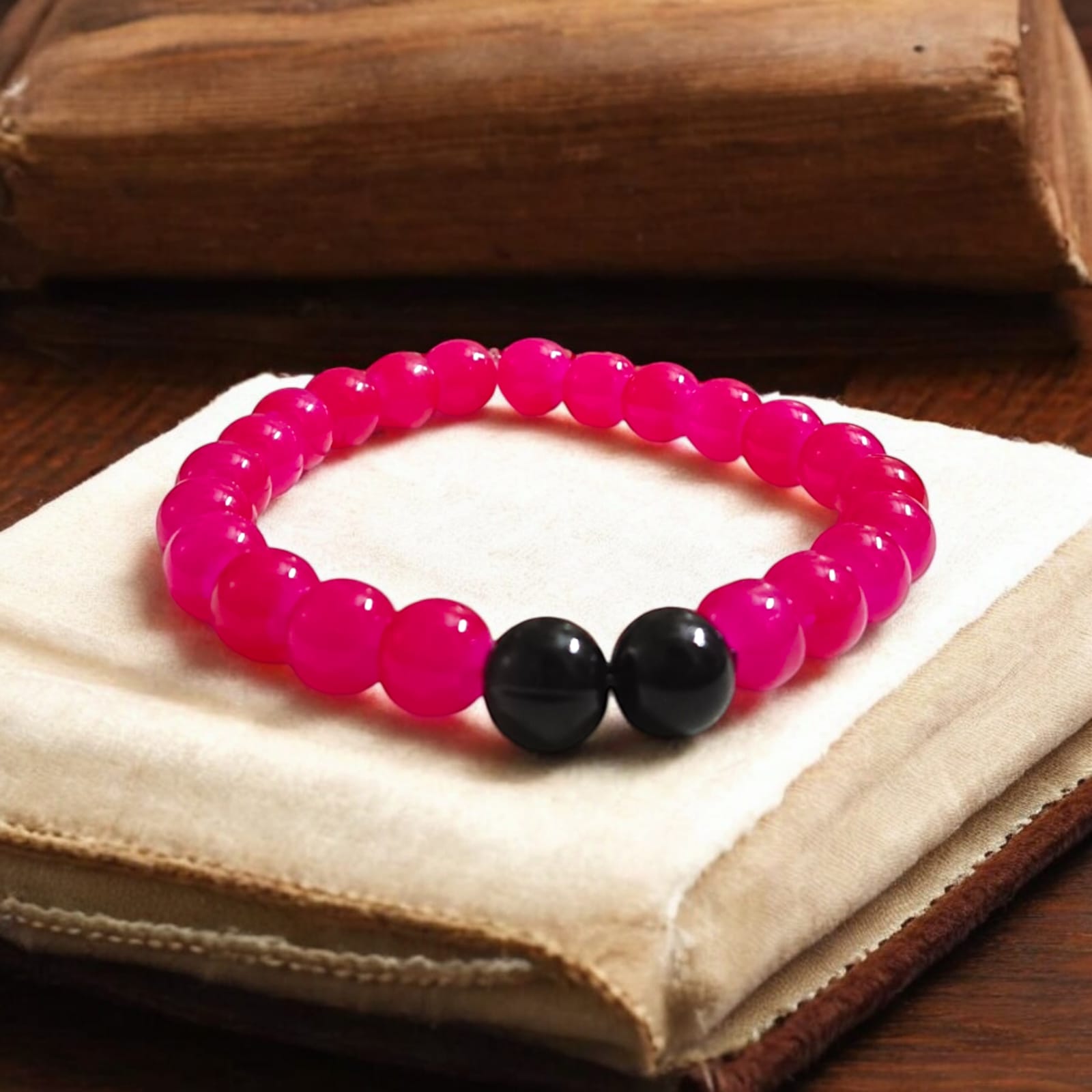 A Pink & Black Agate Bracelet with 8MM lab-certified beads, featuring a stretchable design, ideal for meditation and daily wear.
