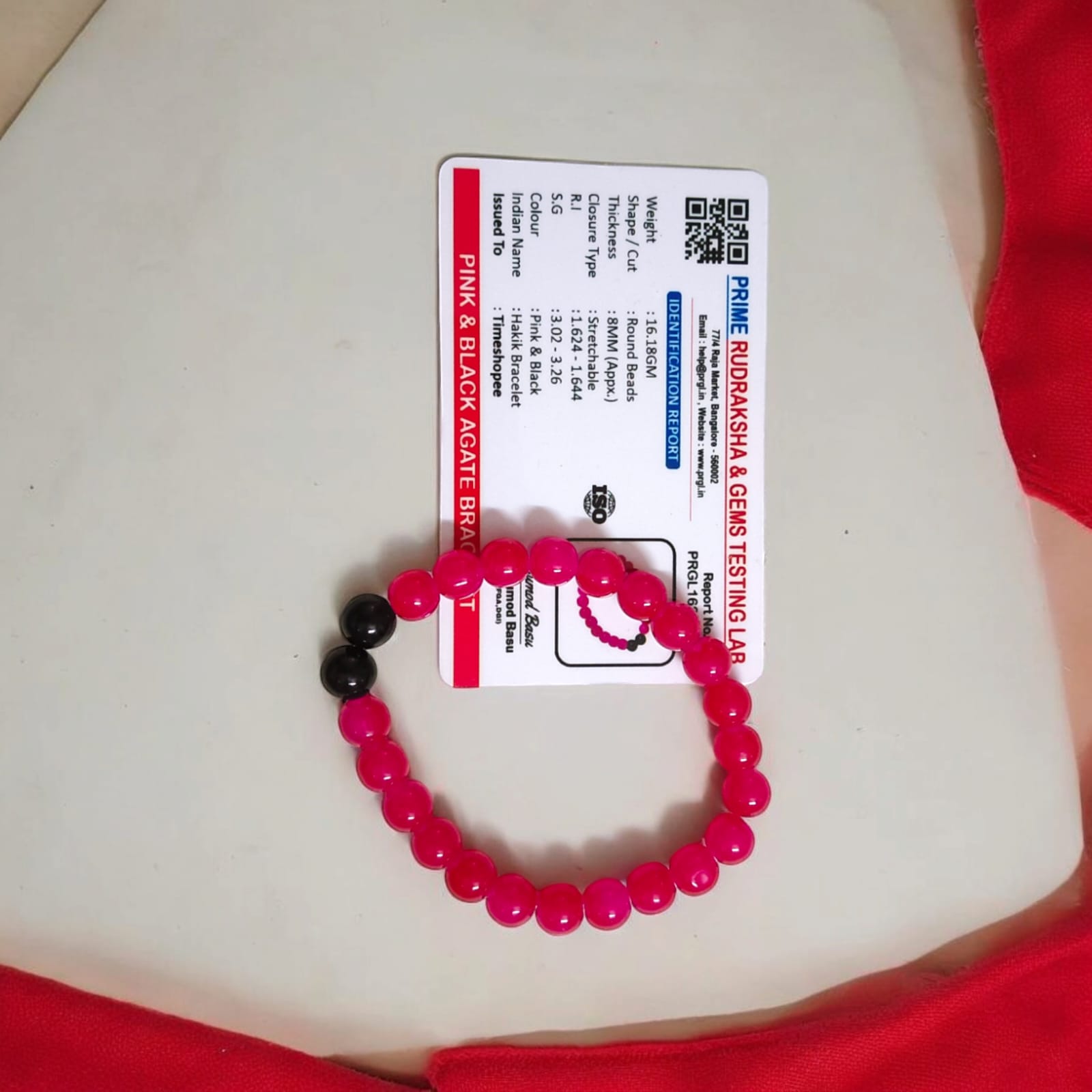 A Pink & Black Agate Bracelet with 8MM lab-certified beads, featuring a stretchable design, ideal for meditation and daily wear.