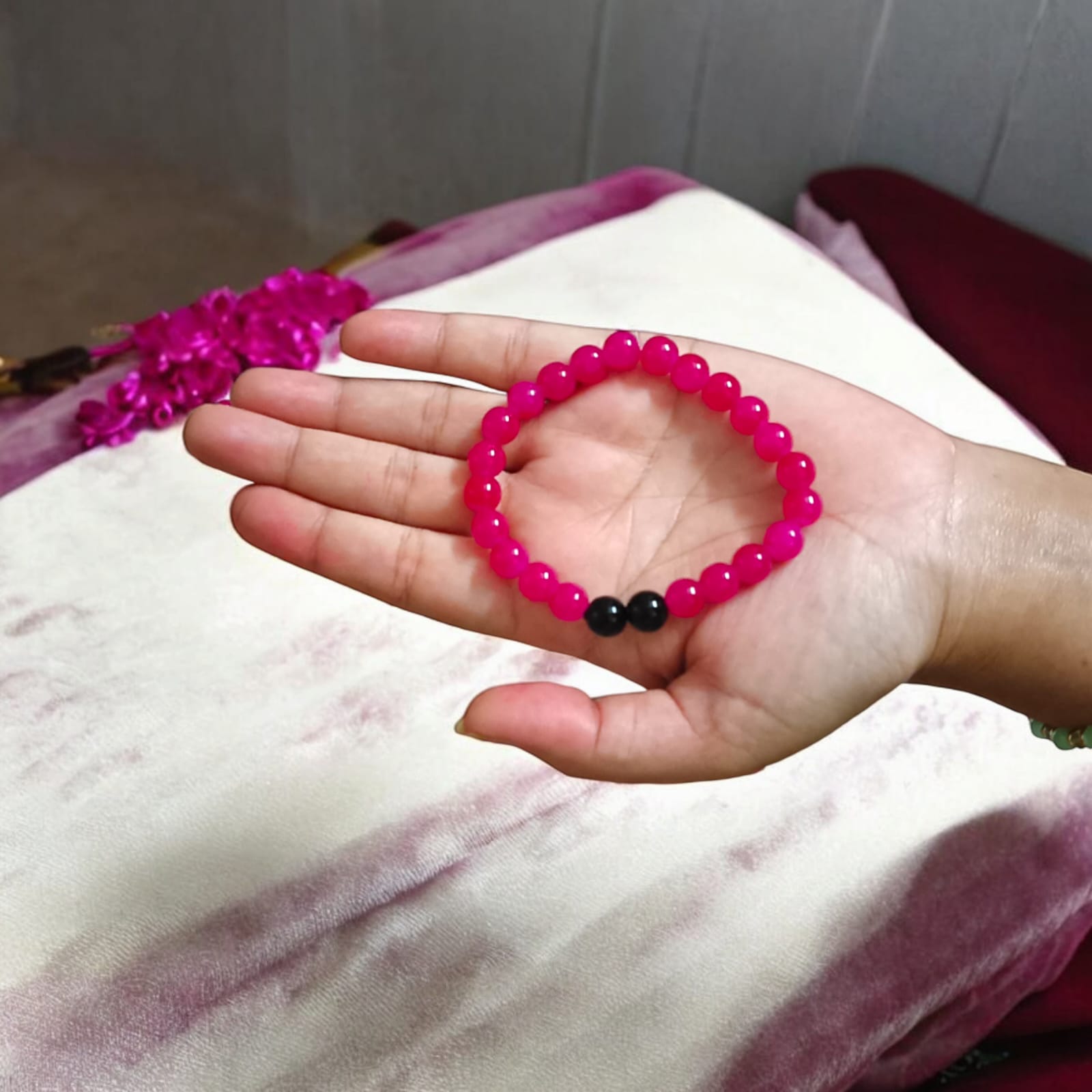 A Pink & Black Agate Bracelet with 8MM lab-certified beads, featuring a stretchable design, ideal for meditation and daily wear.