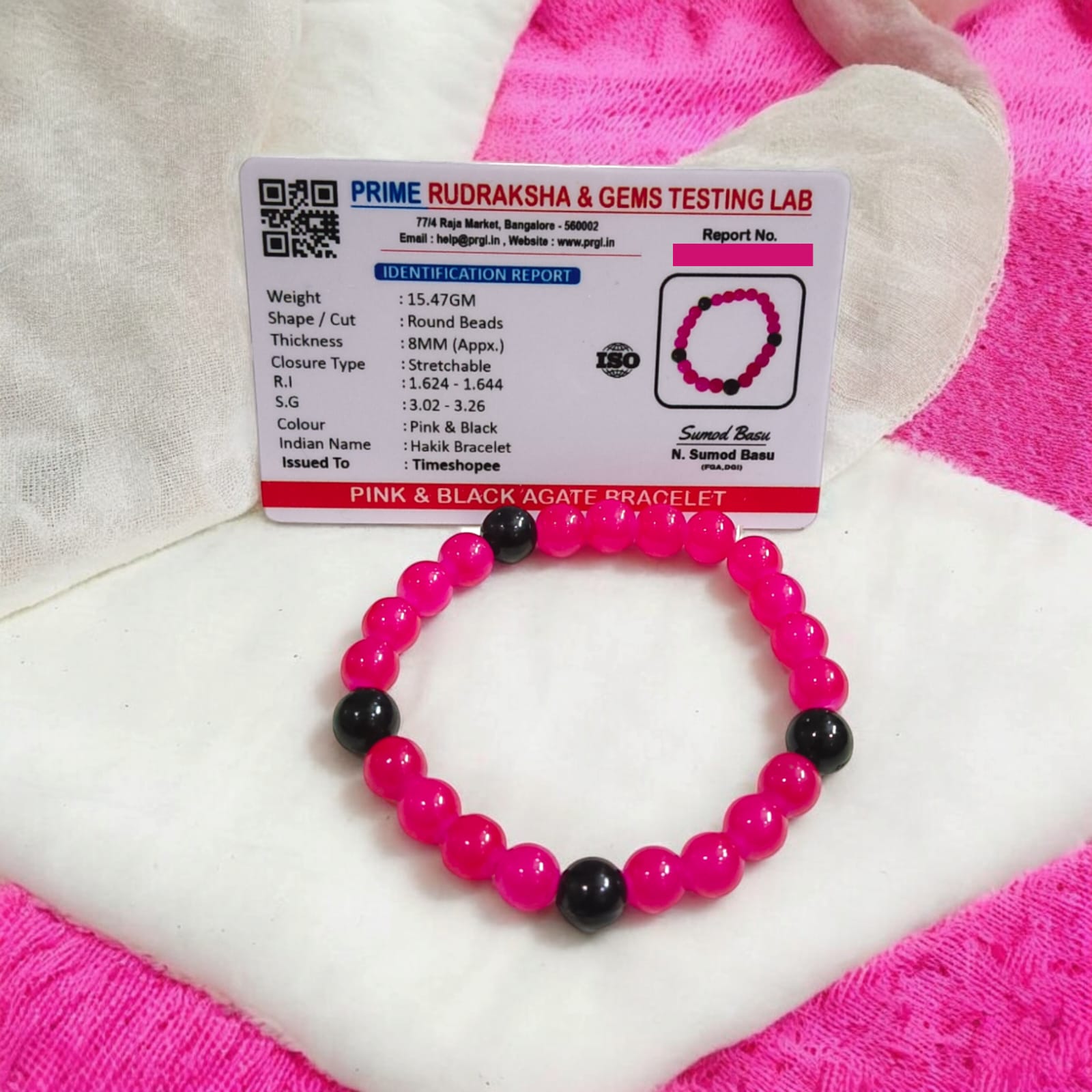 A Pink & Black Agate Bracelet with 8MM lab-certified beads, featuring a stretchable design, ideal for meditation and daily wear.