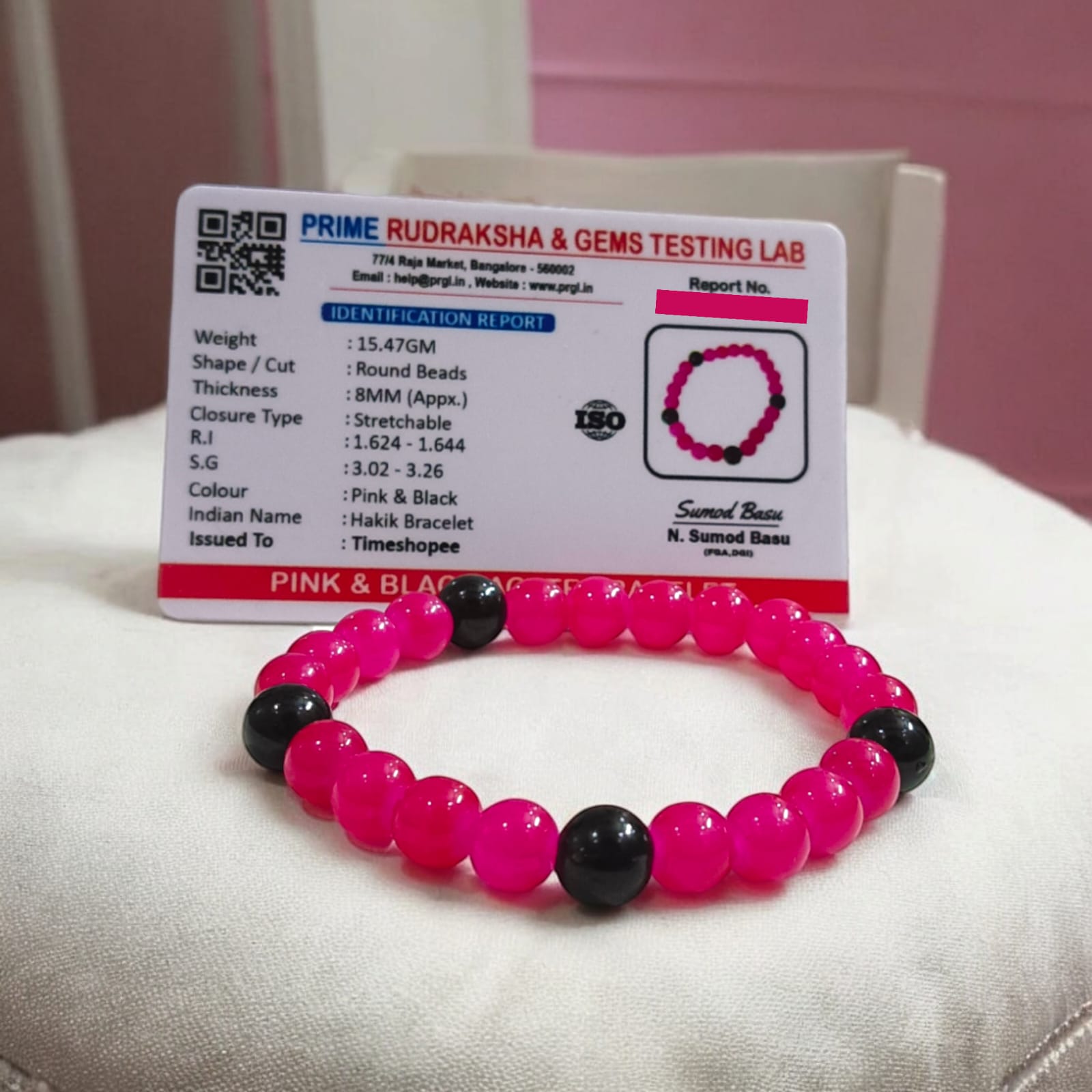 A Pink & Black Agate Bracelet with 8MM lab-certified beads, featuring a stretchable design, ideal for meditation and daily wear.
