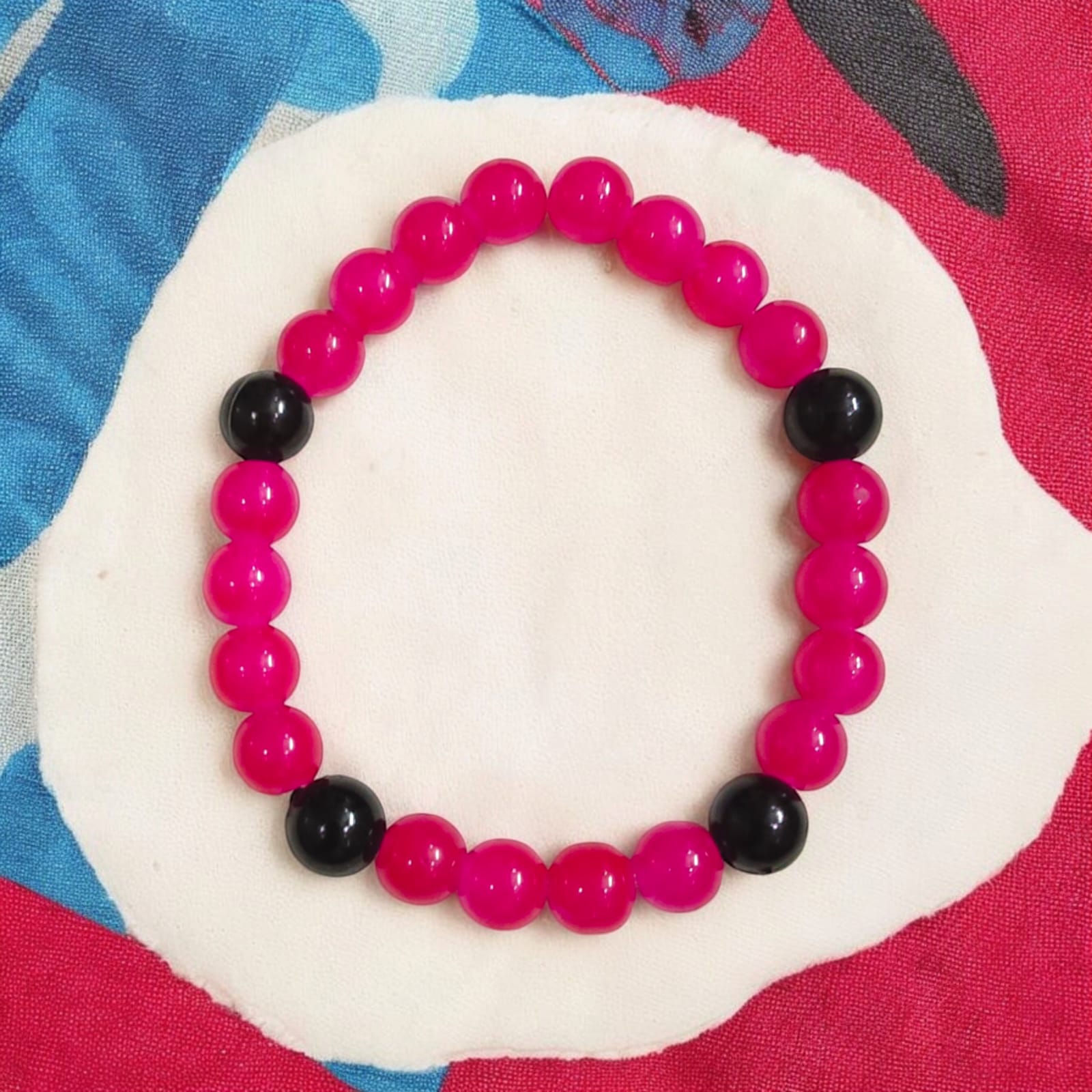 A Pink & Black Agate Bracelet with 8MM lab-certified beads, featuring a stretchable design, ideal for meditation and daily wear.
