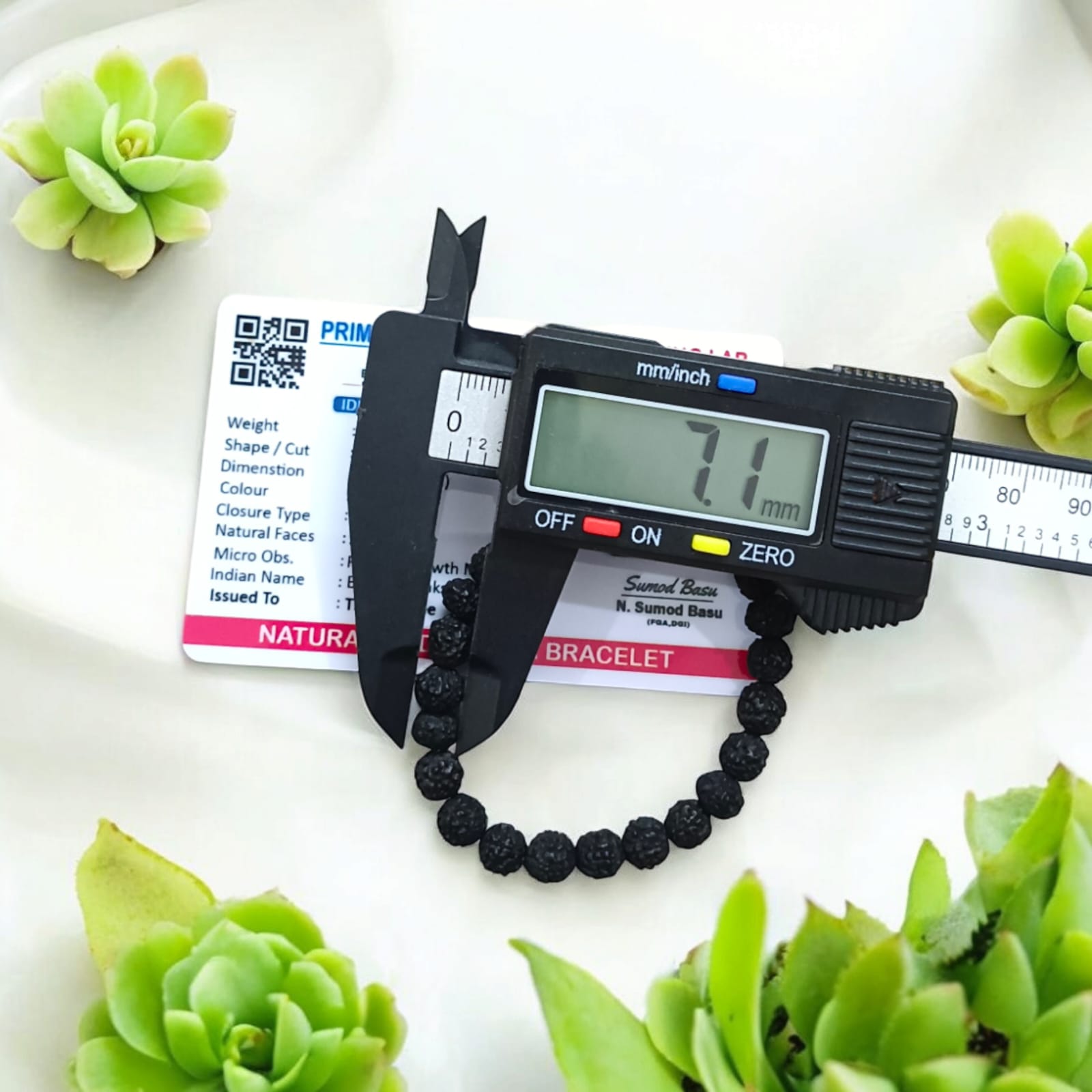 A Black Rudraksha Bracelet with 7MM lab-certified beads, elegantly arranged in a stretchable design, perfect for meditation and daily wear.