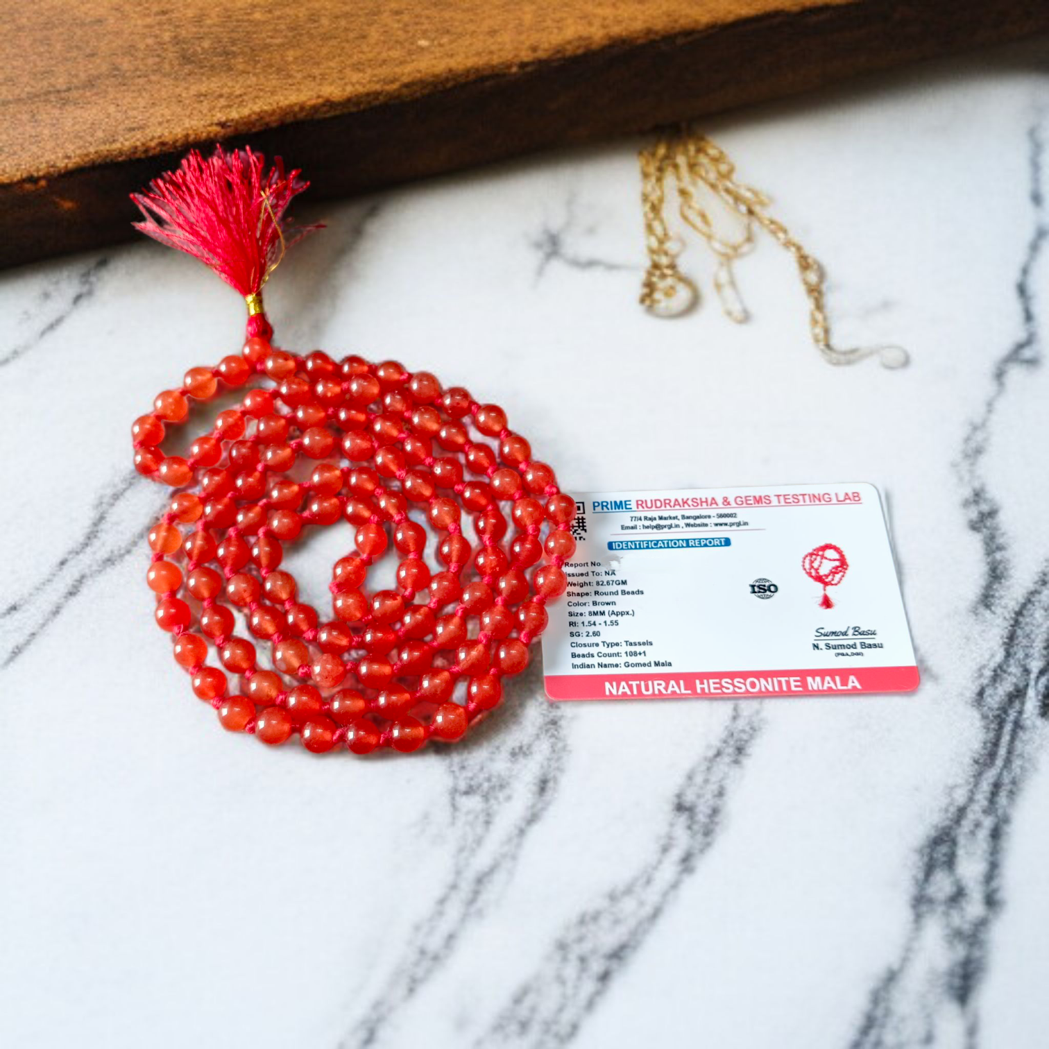 A Hessonite (Gomed) Mala with 27+1 lab-certified deep red gemstone beads, each 8MM in size, designed for meditation, focus, and astrological benefits, ideal for travel, office, and car.
