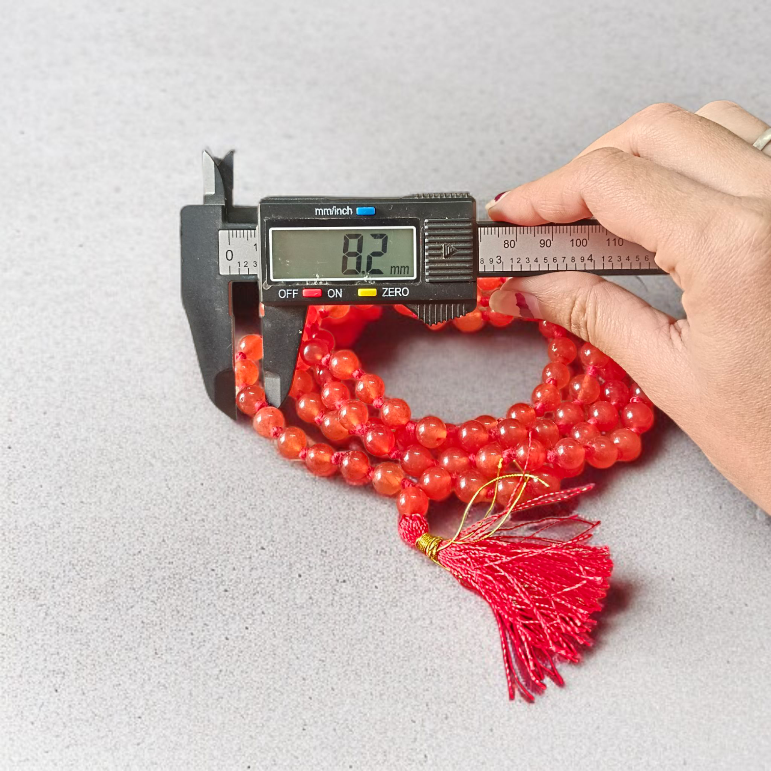 A Hessonite (Gomed) Mala with 27+1 lab-certified deep red gemstone beads, each 8MM in size, designed for meditation, focus, and astrological benefits, ideal for travel, office, and car.