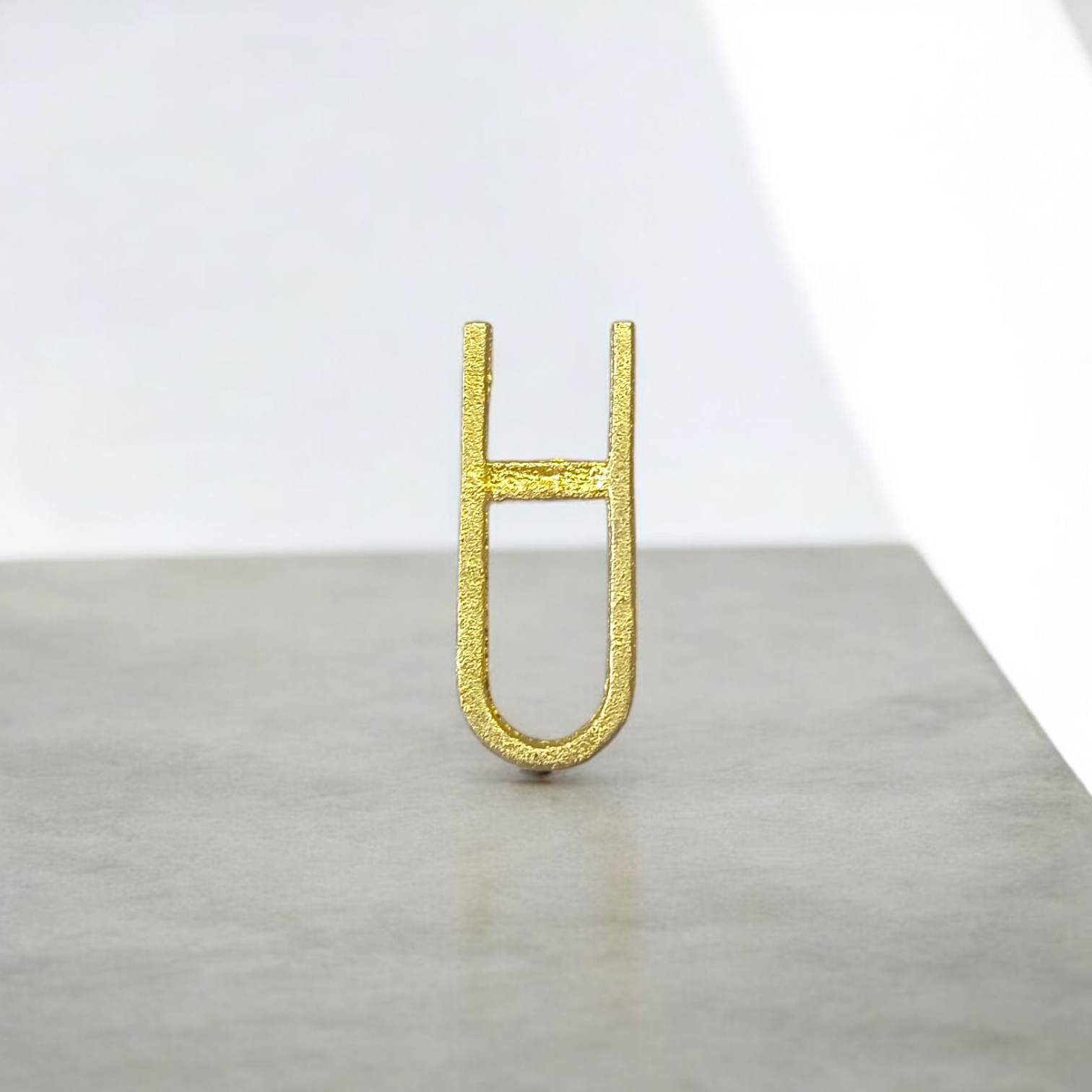 A Vishnu Tilak Stamp made for forehead tilak application, placed on a puja setup with Chandan and Kumkum nearby