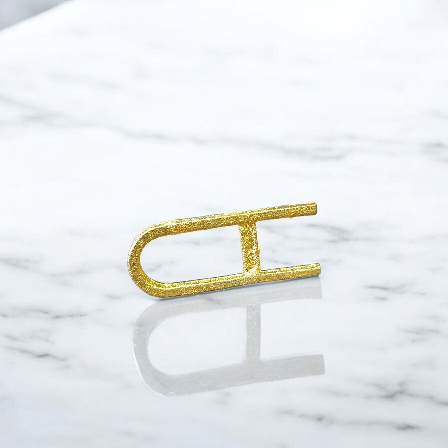 A Vishnu Tilak Stamp made for forehead tilak application, placed on a puja setup with Chandan and Kumkum nearby