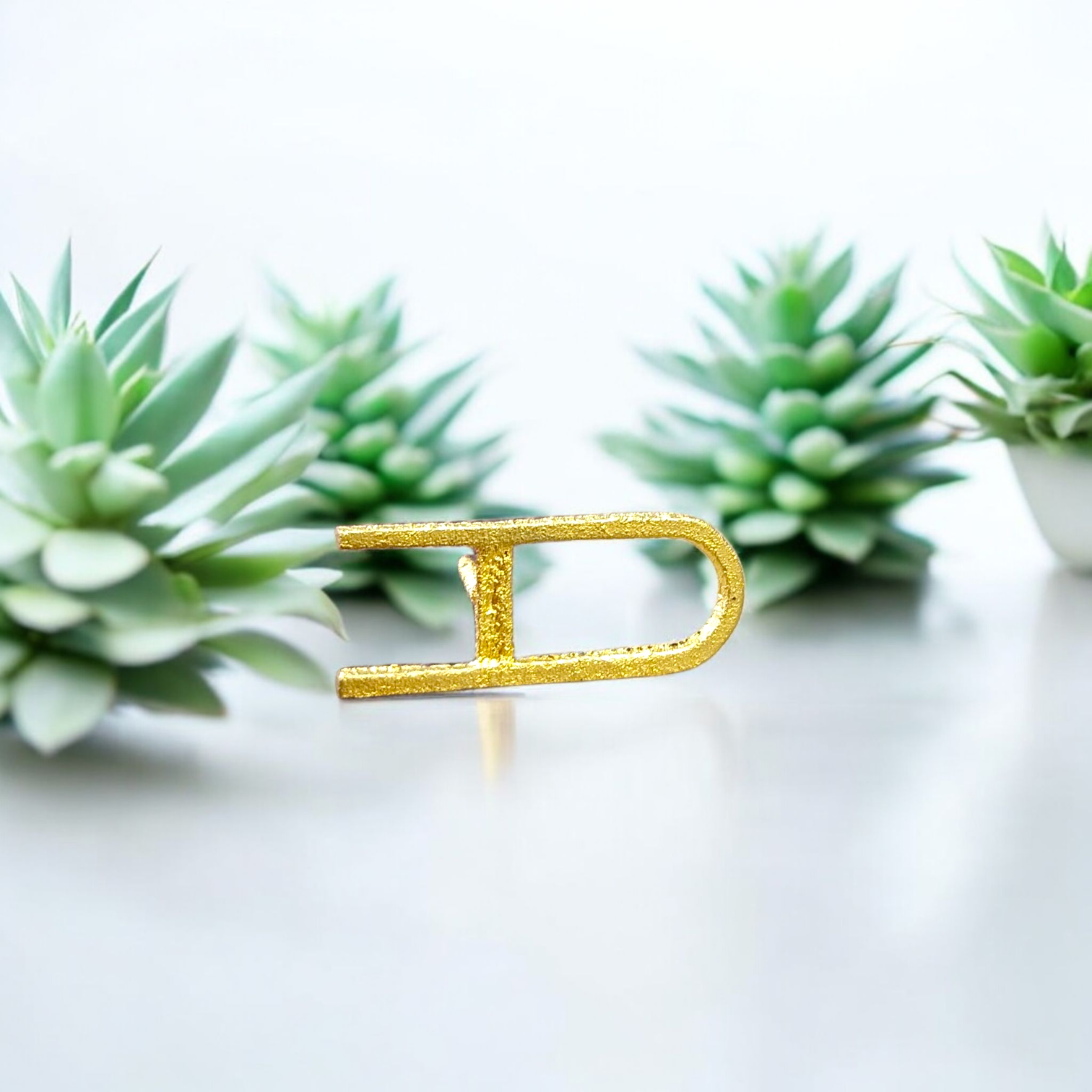 A Vishnu Tilak Stamp made for forehead tilak application, placed on a puja setup with Chandan and Kumkum nearby