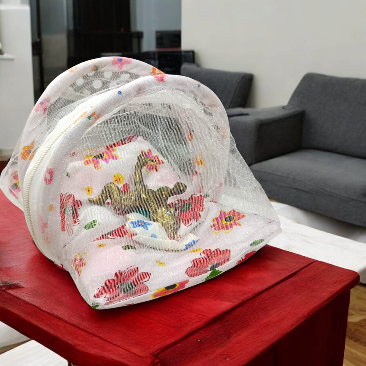 A beautiful 7X10 inch comfortable bed with a mosquito net and three pillows, designed for Laddu Gopal or Radha Rani, available in five vibrant colors for temple use.