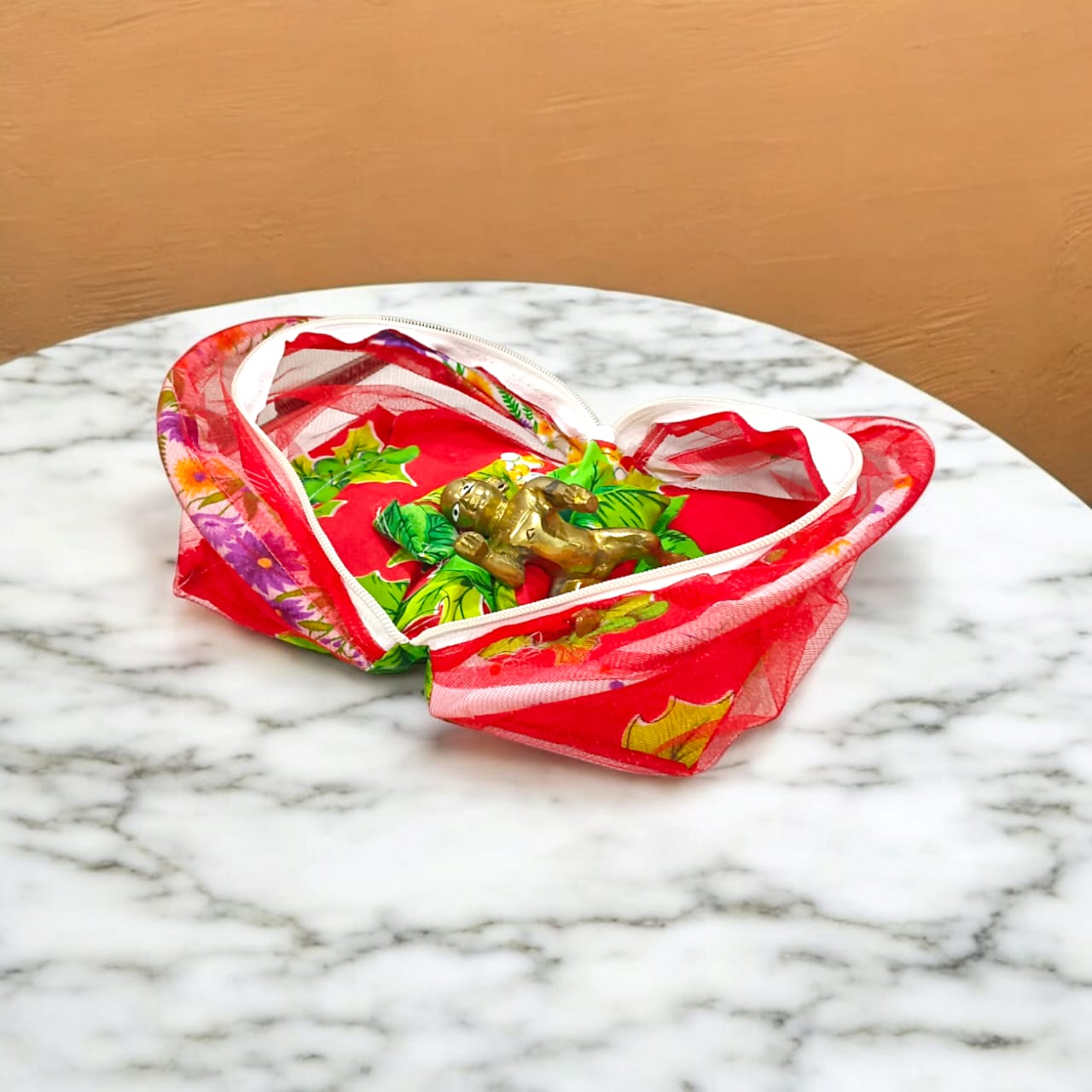 A beautiful 7X10 inch comfortable bed with a mosquito net and three pillows, designed for Laddu Gopal or Radha Rani, available in five vibrant colors for temple use.