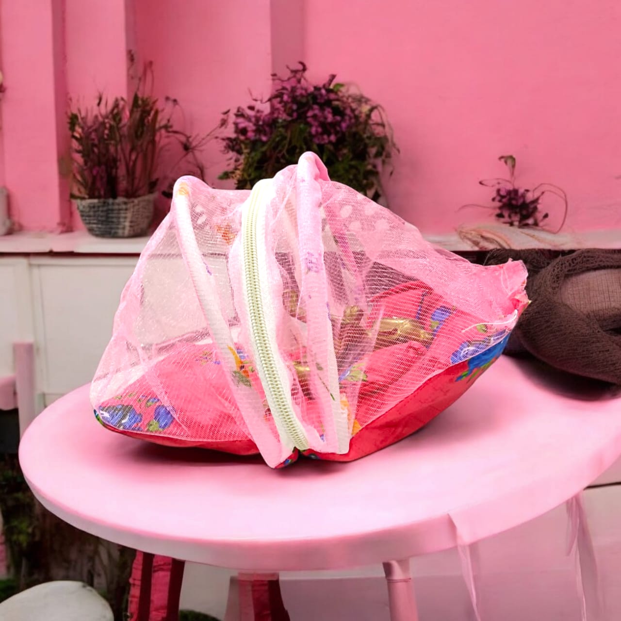 A beautiful 7X10 inch comfortable bed with a mosquito net and three pillows, designed for Laddu Gopal or Radha Rani, available in five vibrant colors for temple use.