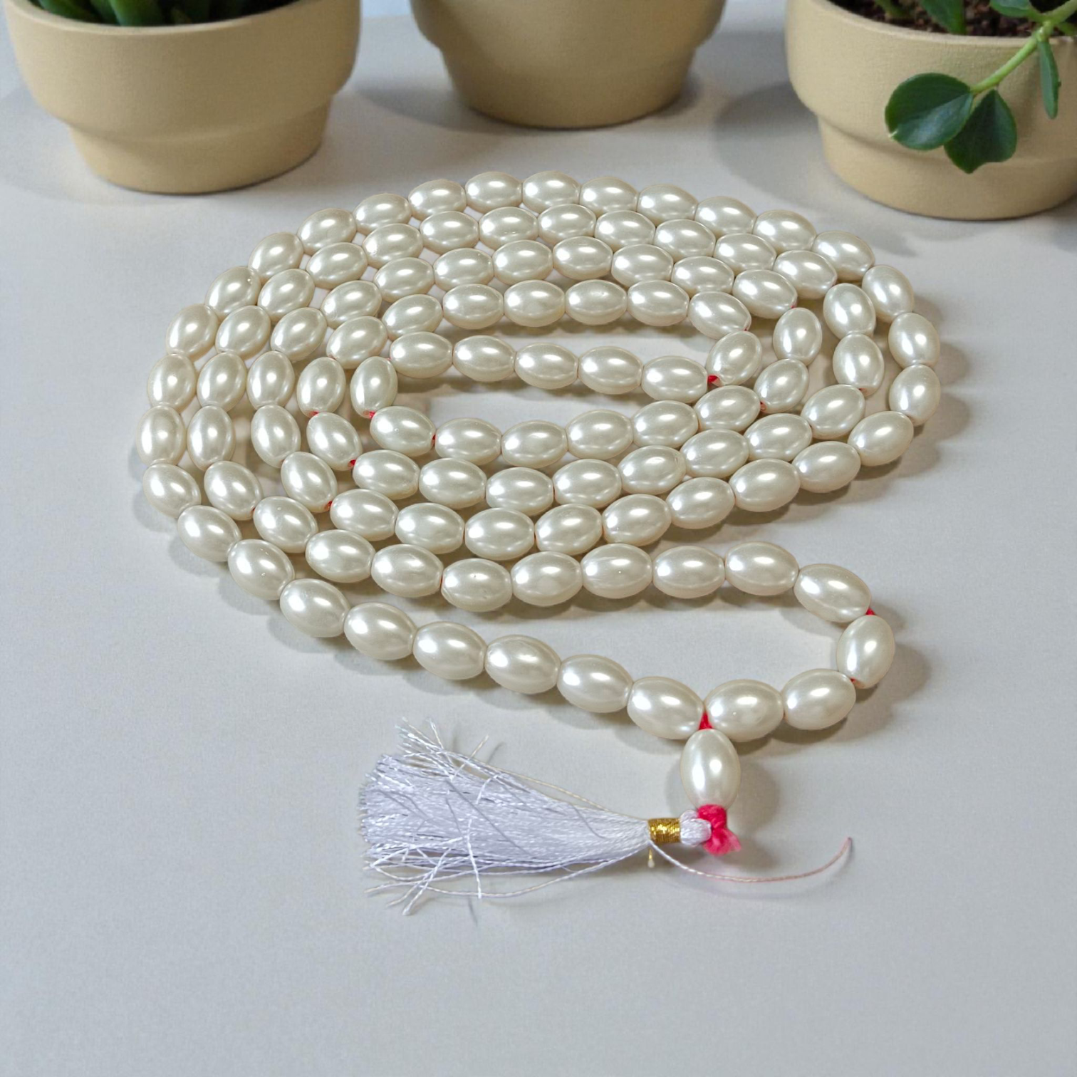 A beautiful Natural Pearl Mala with 108+1 white round beads (10-11mm), handcrafted and lab-certified, ideal for meditation and Japa rituals