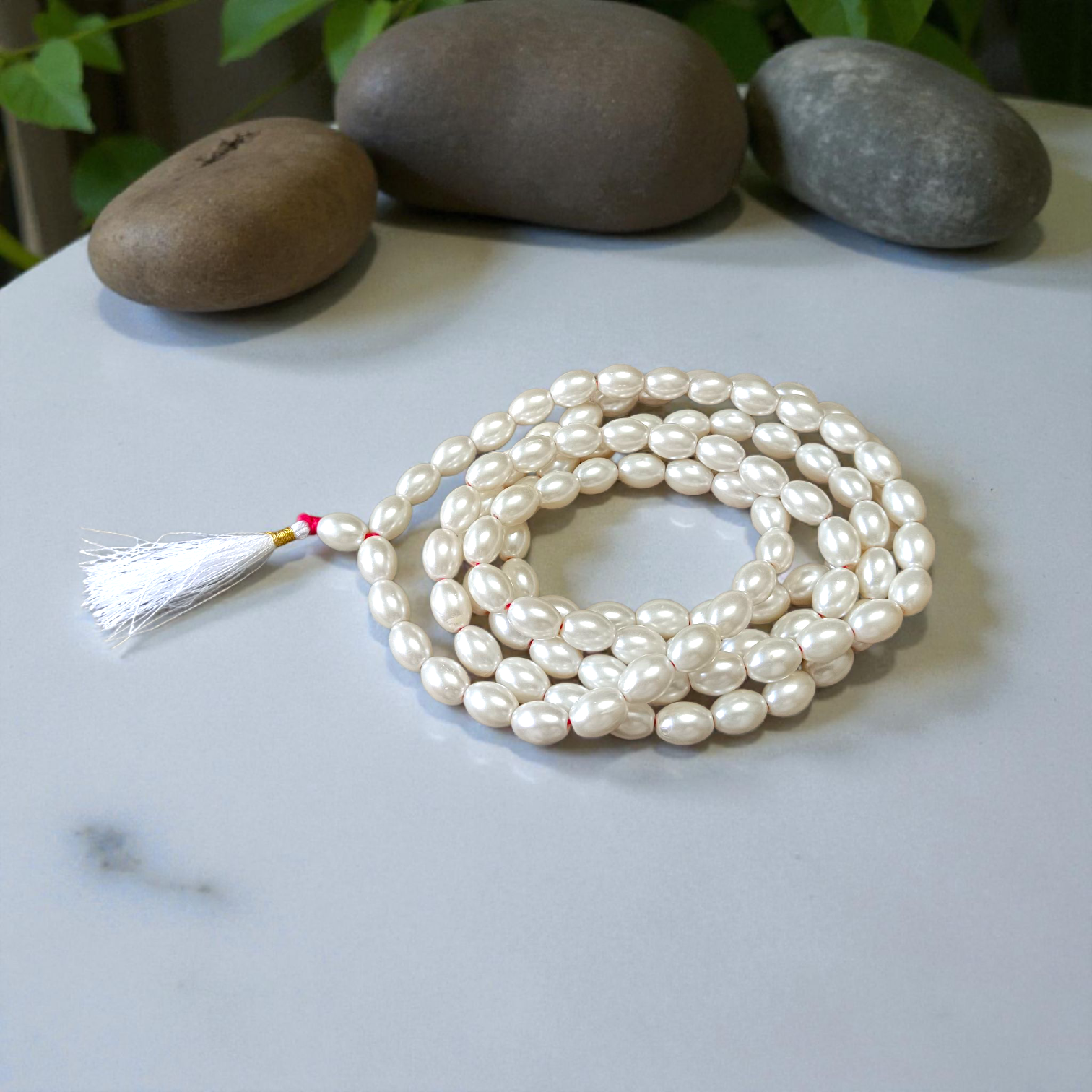 A beautiful Natural Pearl Mala with 108+1 white round beads (10-11mm), handcrafted and lab-certified, ideal for meditation and Japa rituals
