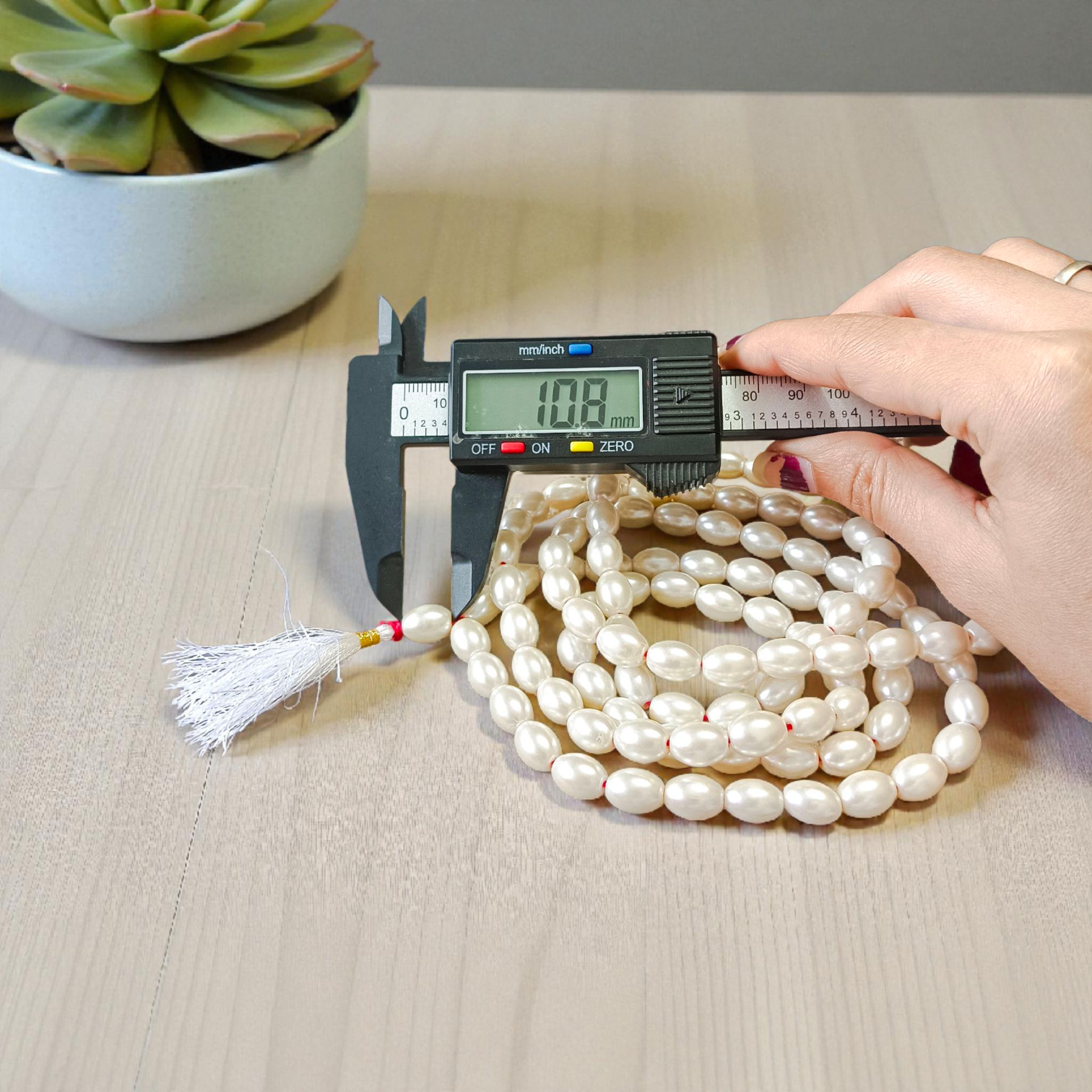 A beautiful Natural Pearl Mala with 108+1 white round beads (10-11mm), handcrafted and lab-certified, ideal for meditation and Japa rituals