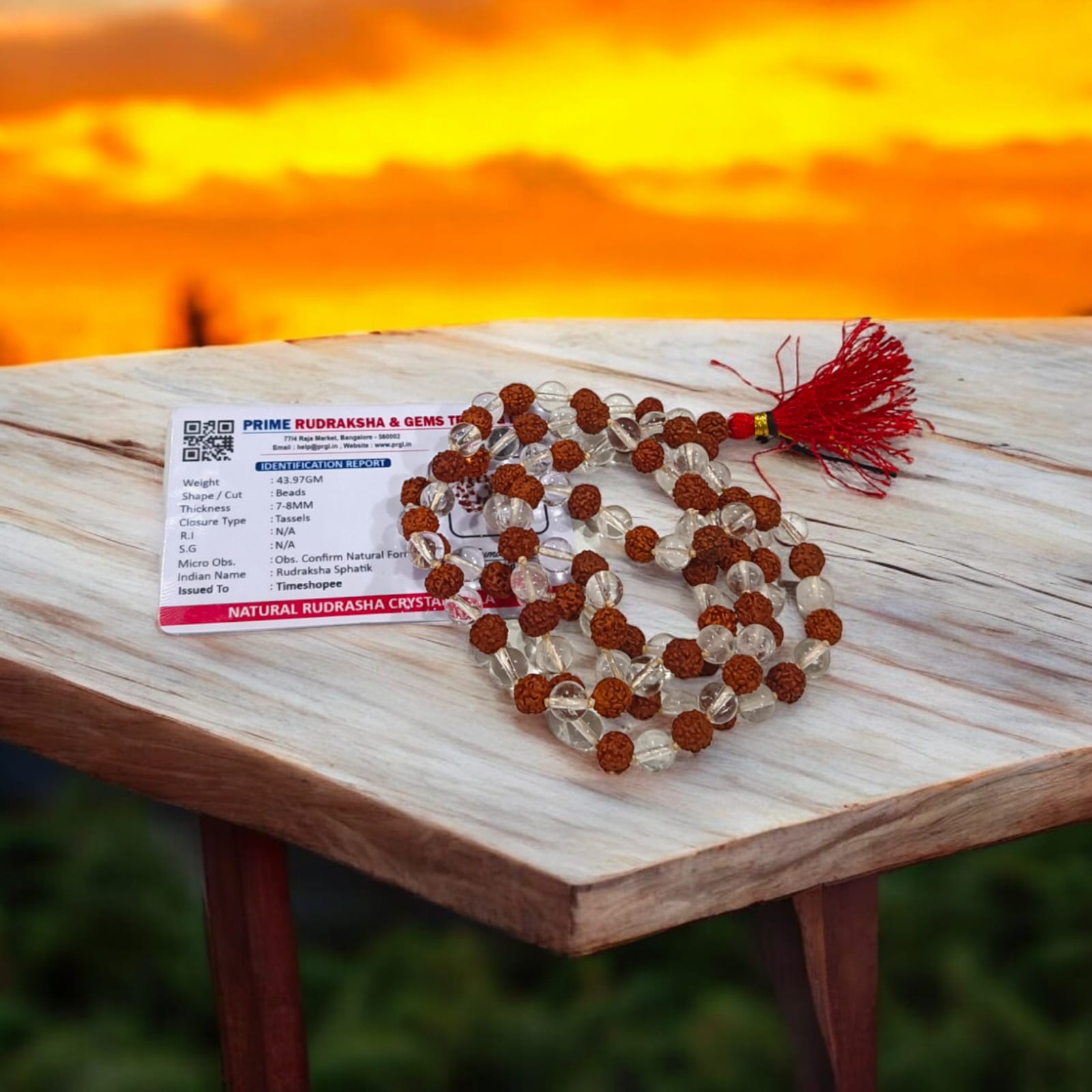 A beautiful Rudraksha and Sphatik Crystal Mala with natural beads, arranged neatly, available in 27+1 and 108+1 variants, displayed on a spiritual-themed background