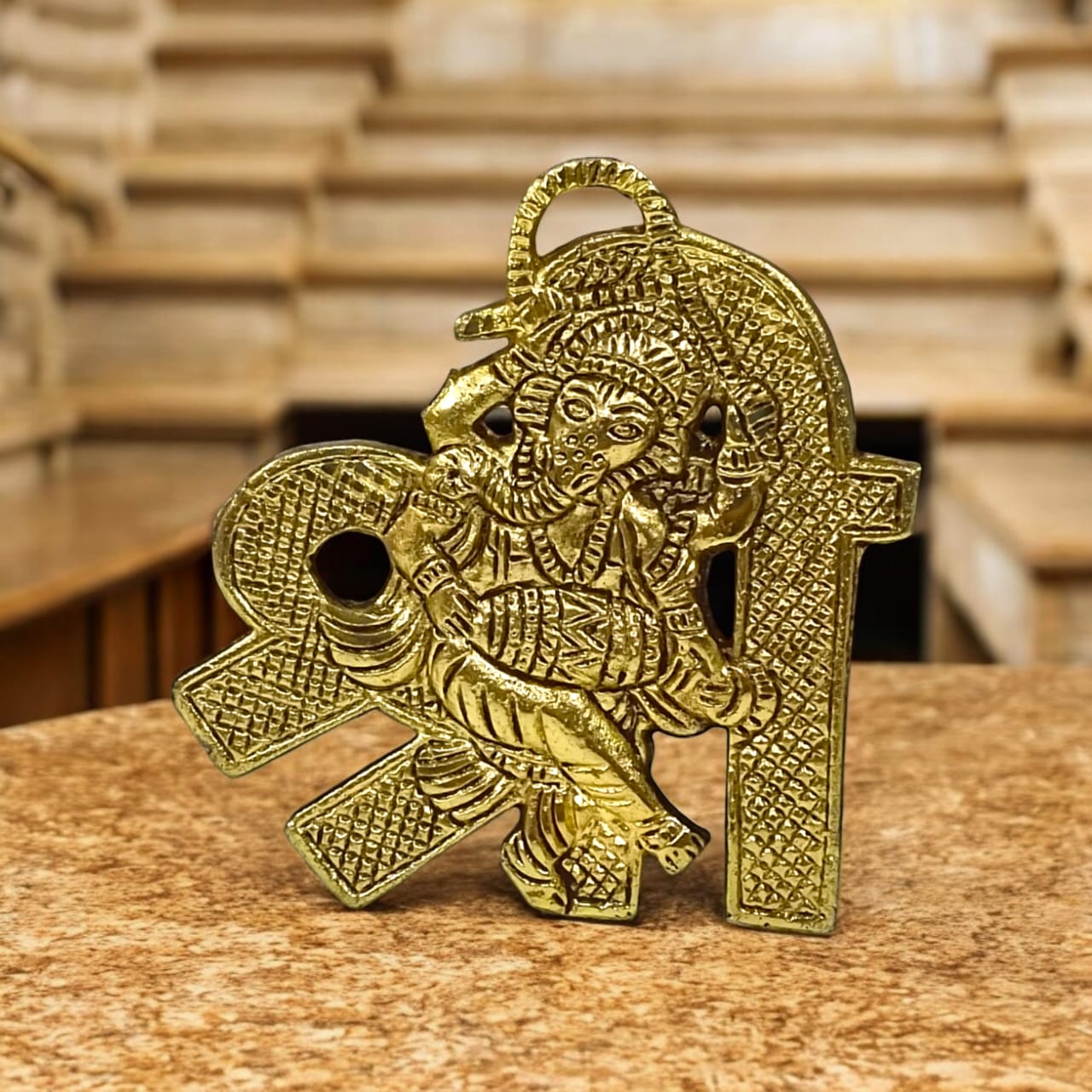 A beautifully crafted brass wall hanging of Shri Ganesh, measuring 11X11 CM, suitable for decorating temple walls, office spaces, and home doors.