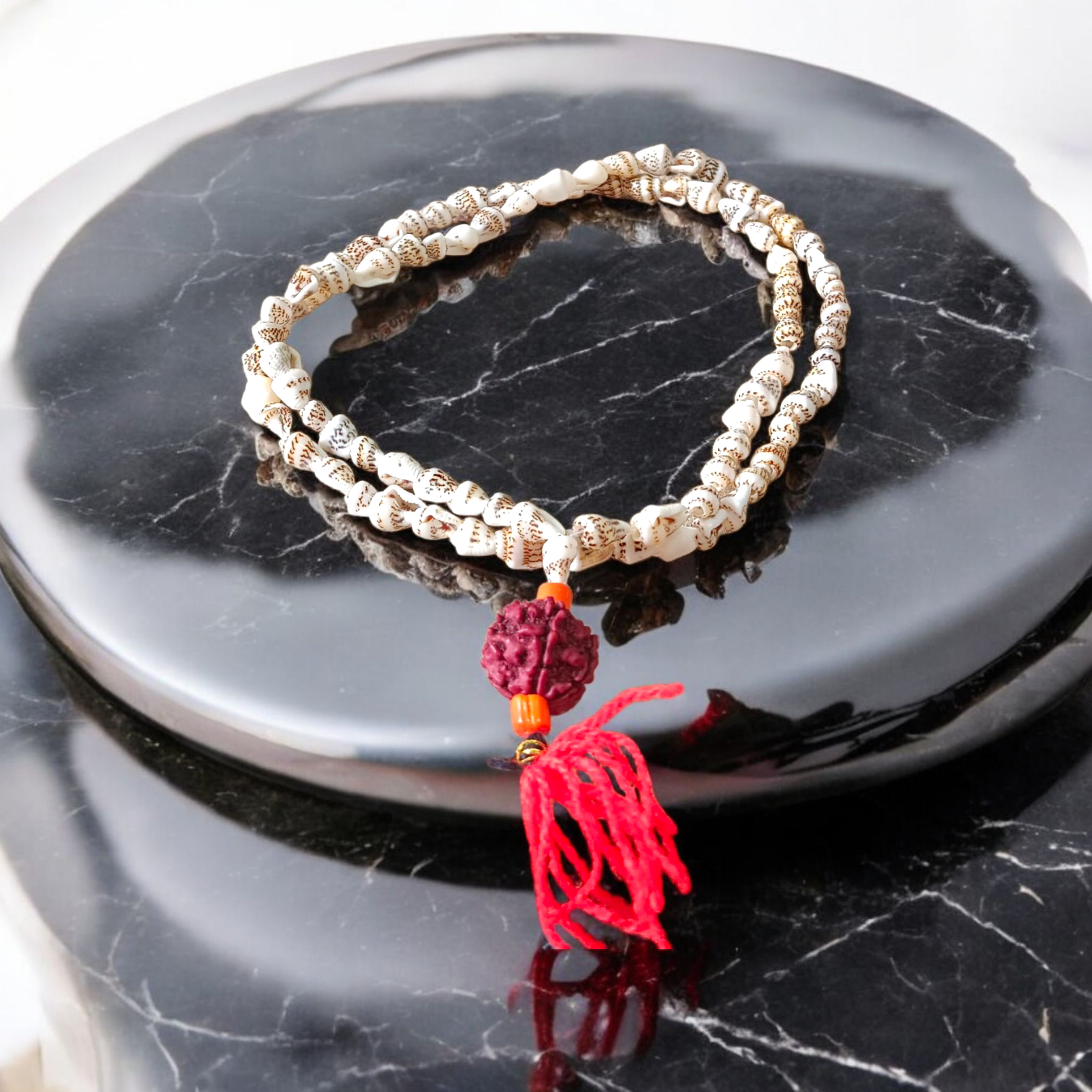 A beautifully handcrafted Shankh Mala (Conch Mala) made from white conch shells, used for meditation and spiritual practices, displayed with certification