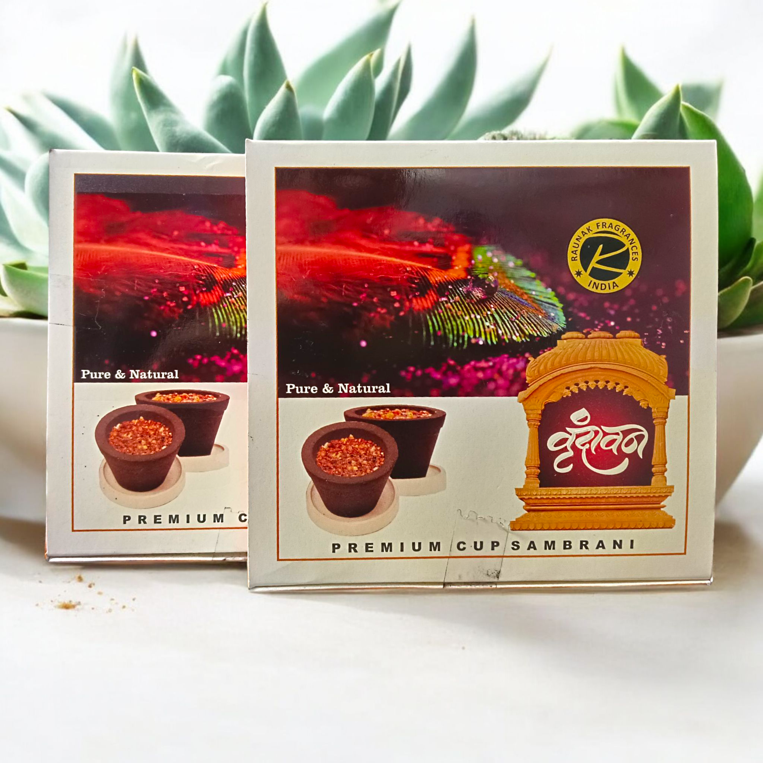 A box of Premium Cup Sambrani containing 12 natural dhoop cups arranged neatly, with herbal ingredients in the background
