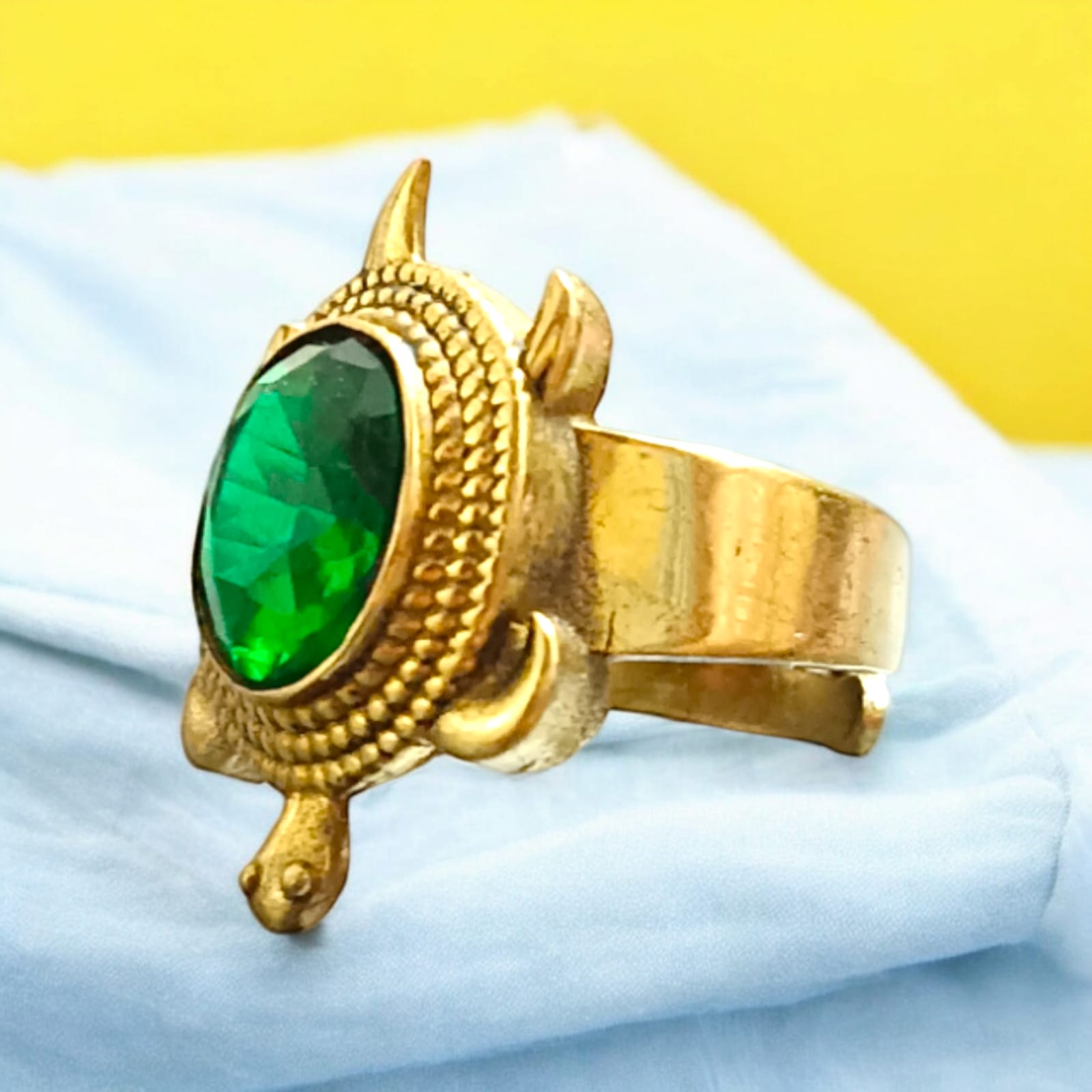 A close-up of the Kachua Panna Ring, featuring a green Panna gemstone set in a tortoise-shaped design made from Ashtdhatu. The ring is adjustable and suitable for men and women.