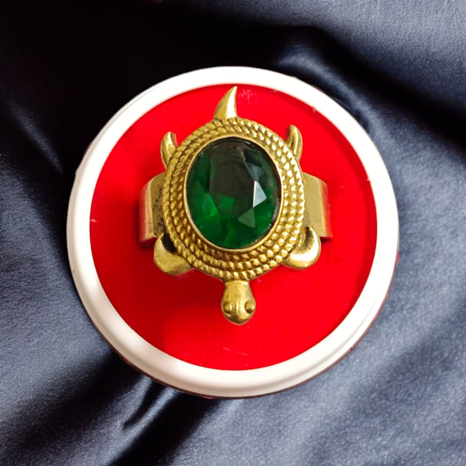 A close-up of the Kachua Panna Ring, featuring a green Panna gemstone set in a tortoise-shaped design made from Ashtdhatu. The ring is adjustable and suitable for men and women.