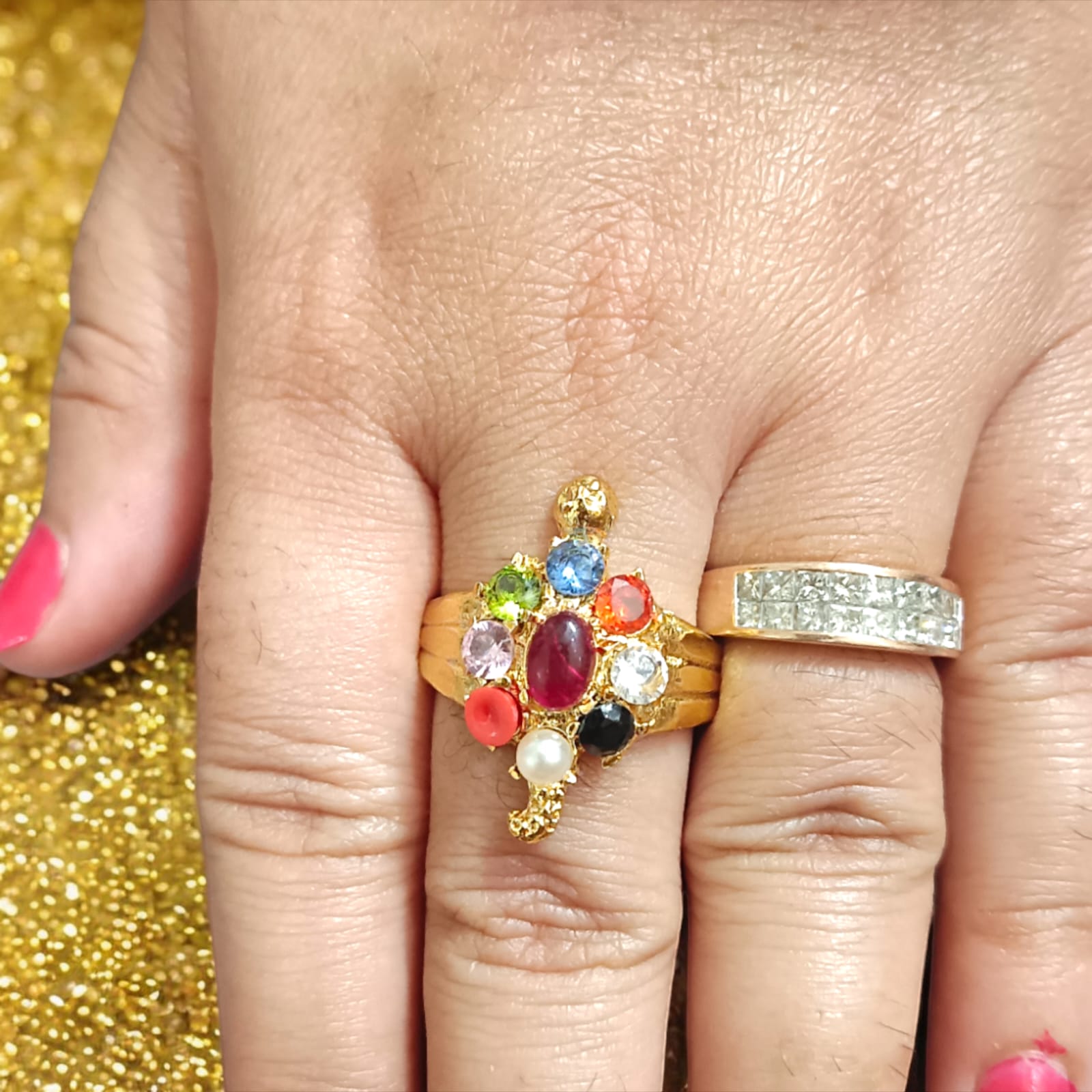 A close-up view of the Navratna Kachua Ring, featuring an array of nine Navratna gemstones set in a gold-plated tortoise-shaped design. The ring is adjustable and suitable for both men and women.