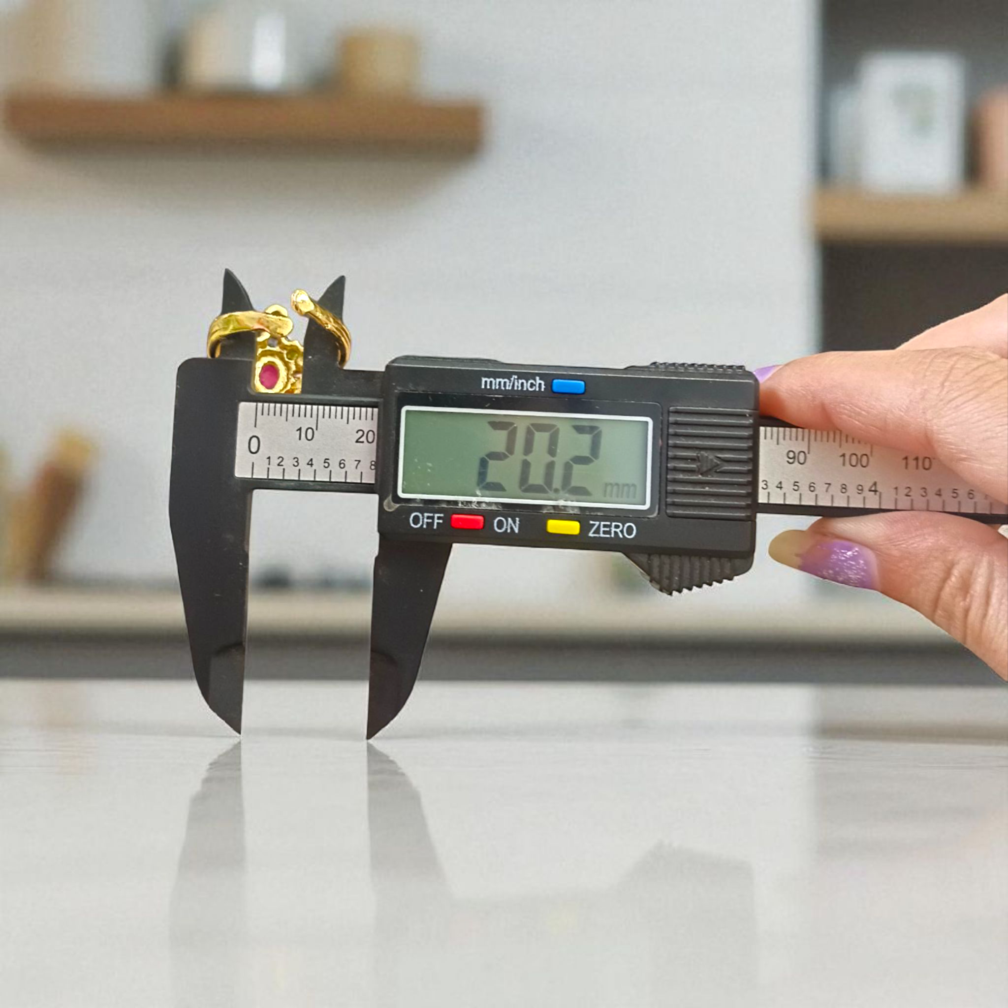 A close-up view of the Navratna Kachua Ring, featuring an array of nine Navratna gemstones set in a gold-plated tortoise-shaped design. The ring is adjustable and suitable for both men and women.