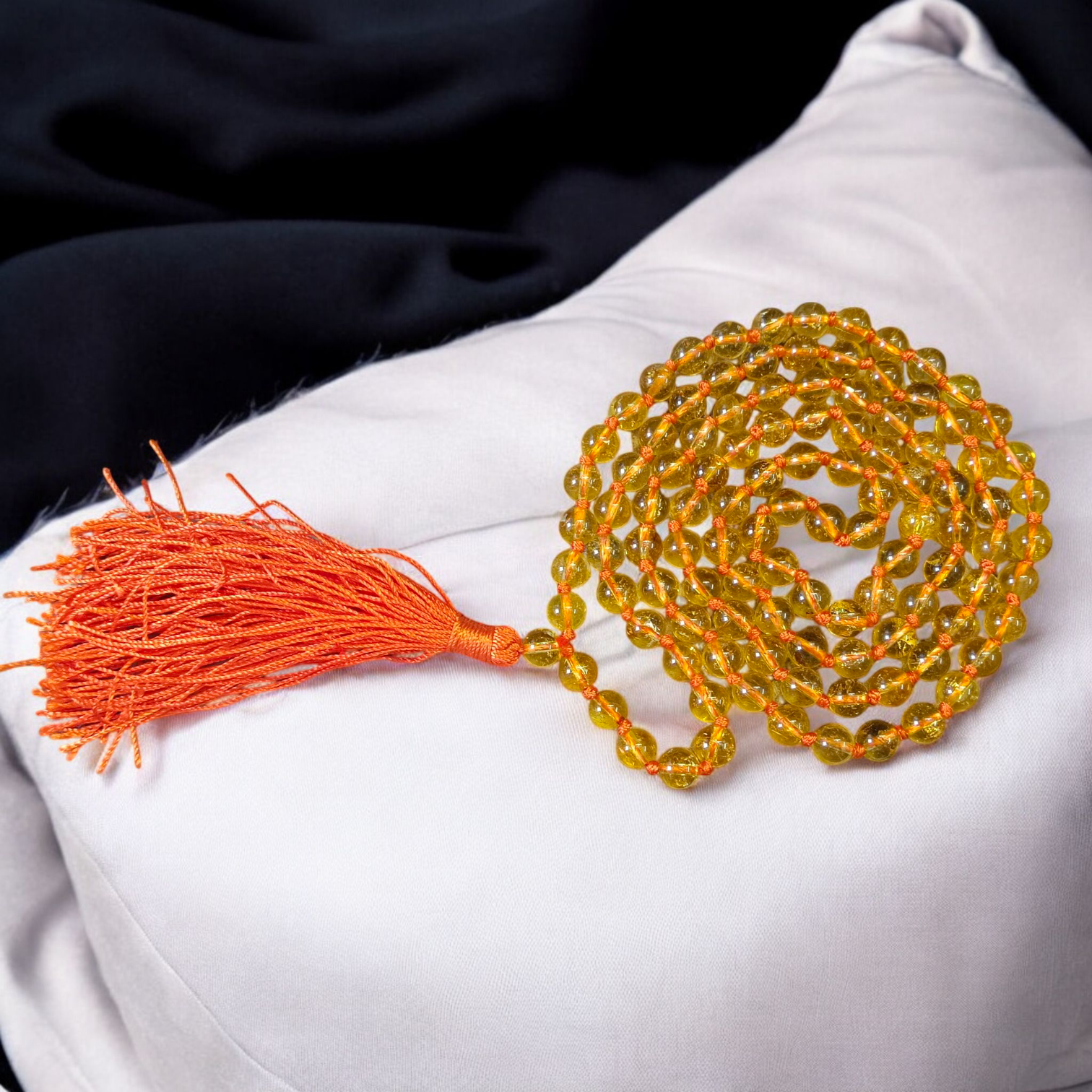 A handcrafted Citrine Mala made of 108+1 golden-yellow 8mm beads, used for meditation, energy healing, and Japa, displayed on a wooden background