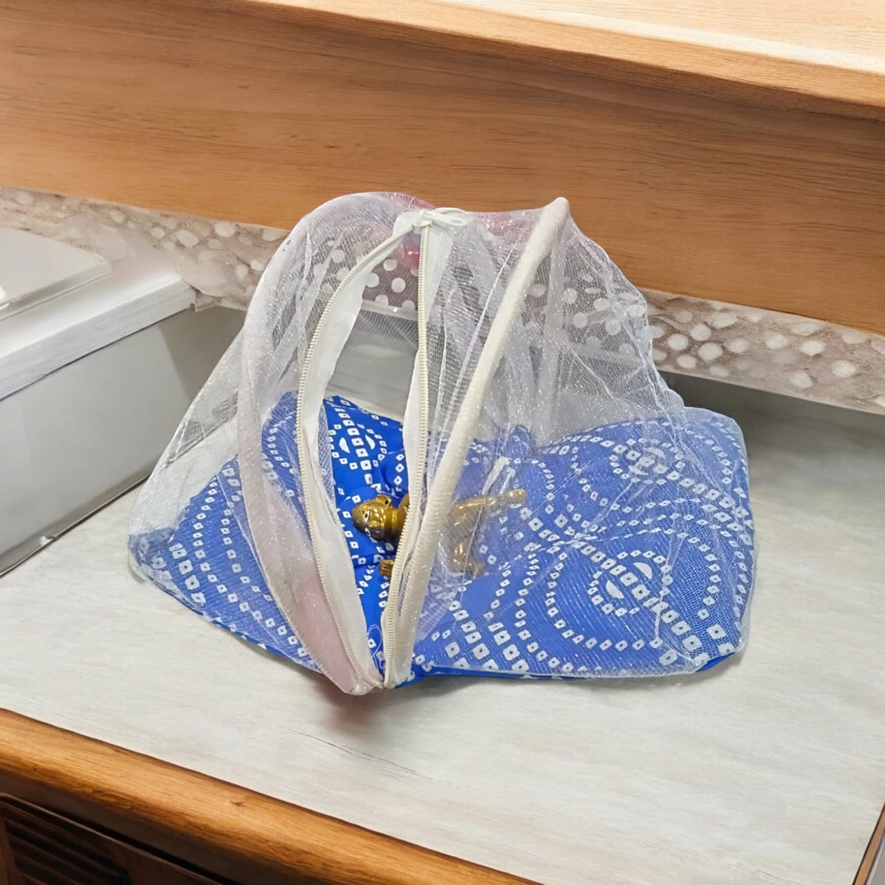 A large 10X13 inch comfortable bed with a mosquito net and three pillows, designed for Laddu Gopal or Radha Rani, available in Pink and Blue for home temple use.