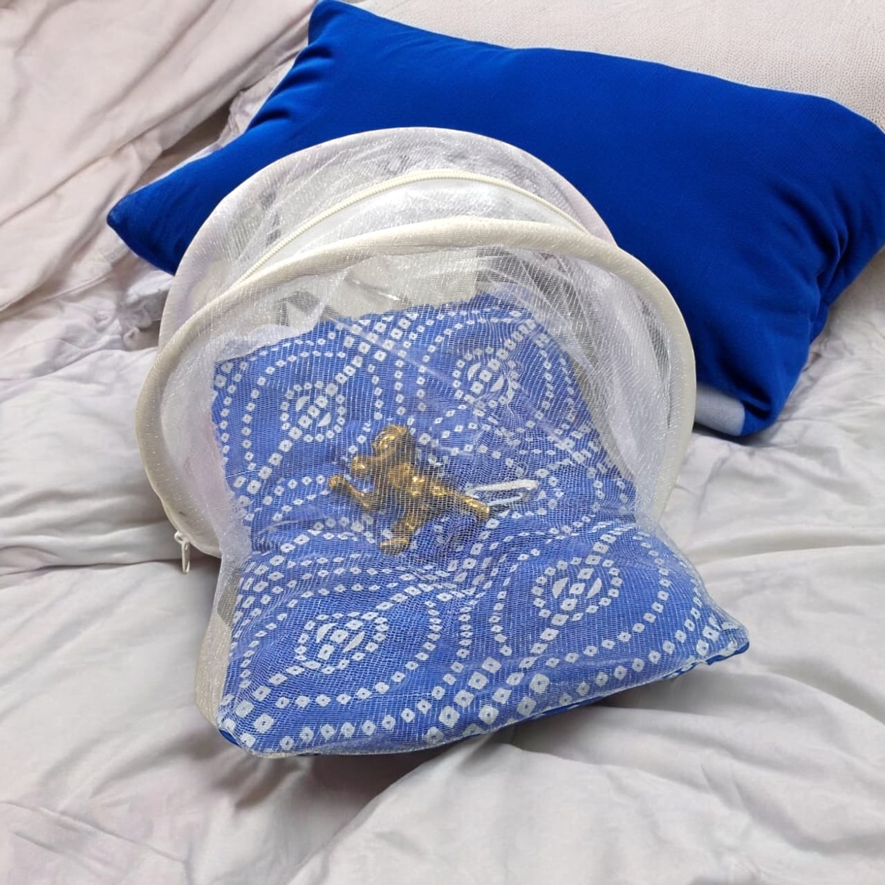 A large 10X13 inch comfortable bed with a mosquito net and three pillows, designed for Laddu Gopal or Radha Rani, available in Pink and Blue for home temple use.