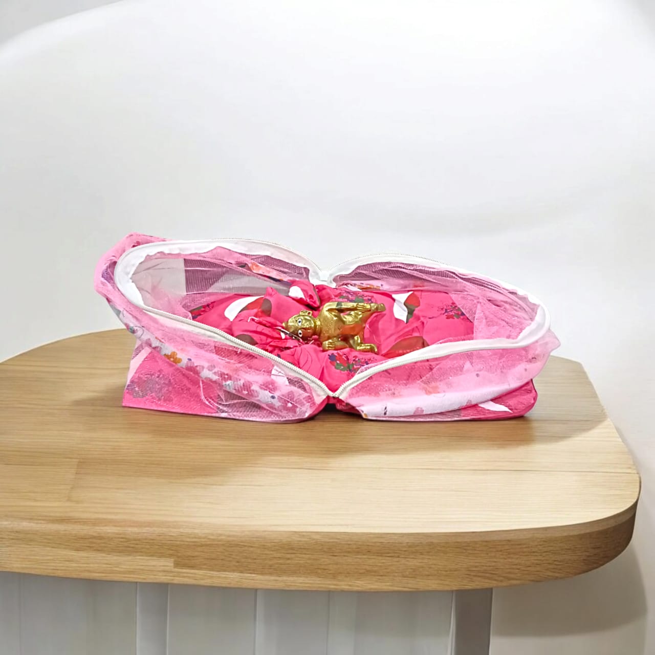 A large 10X13 inch comfortable bed with a mosquito net and three pillows, designed for Laddu Gopal or Radha Rani, available in Pink and Blue for home temple use.