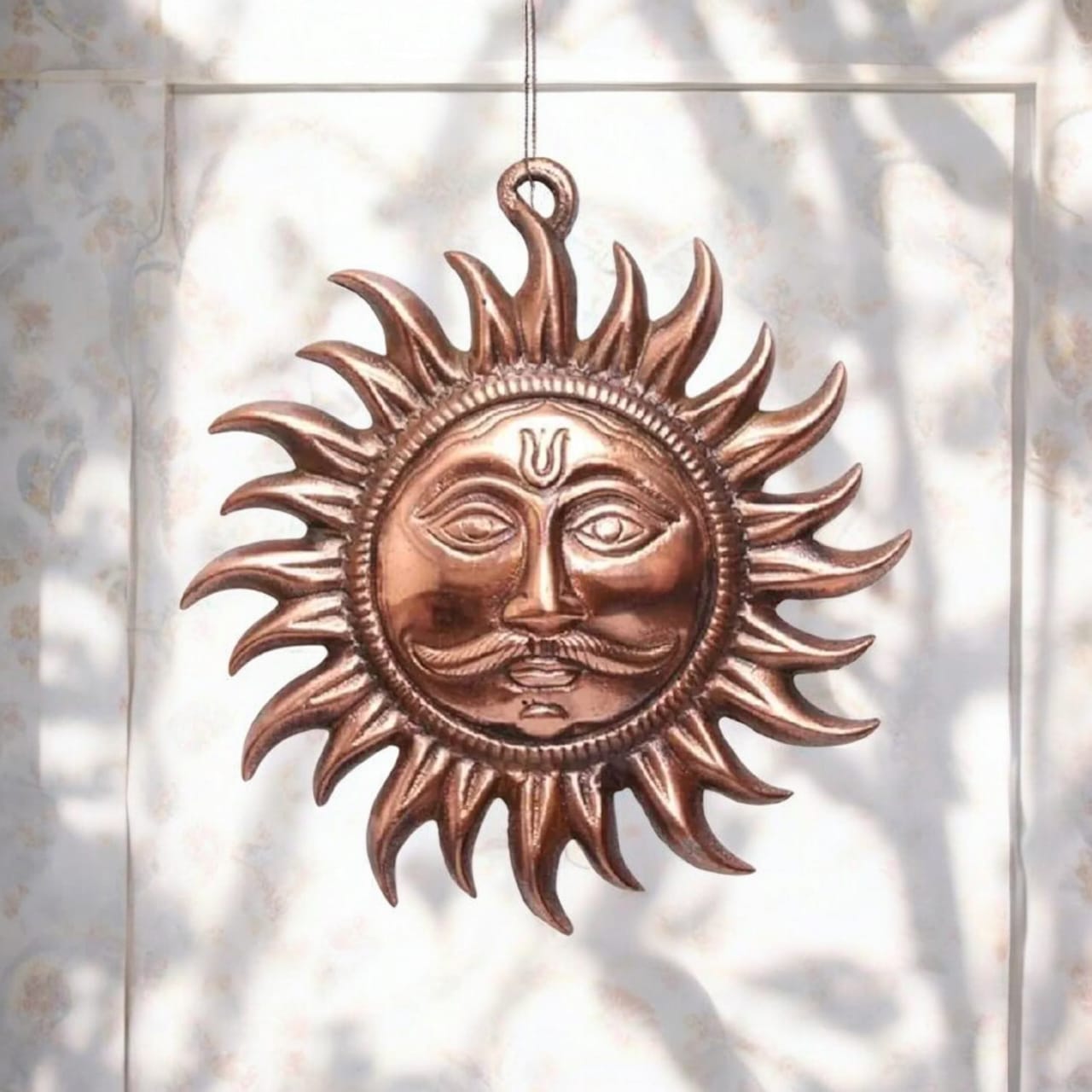 A pure copper wall hanging sun, symbolizing strength and positivity, available in small (5 inch) and big (7 inch) sizes to protect from Vaastu Dosh and Shani Dosh.