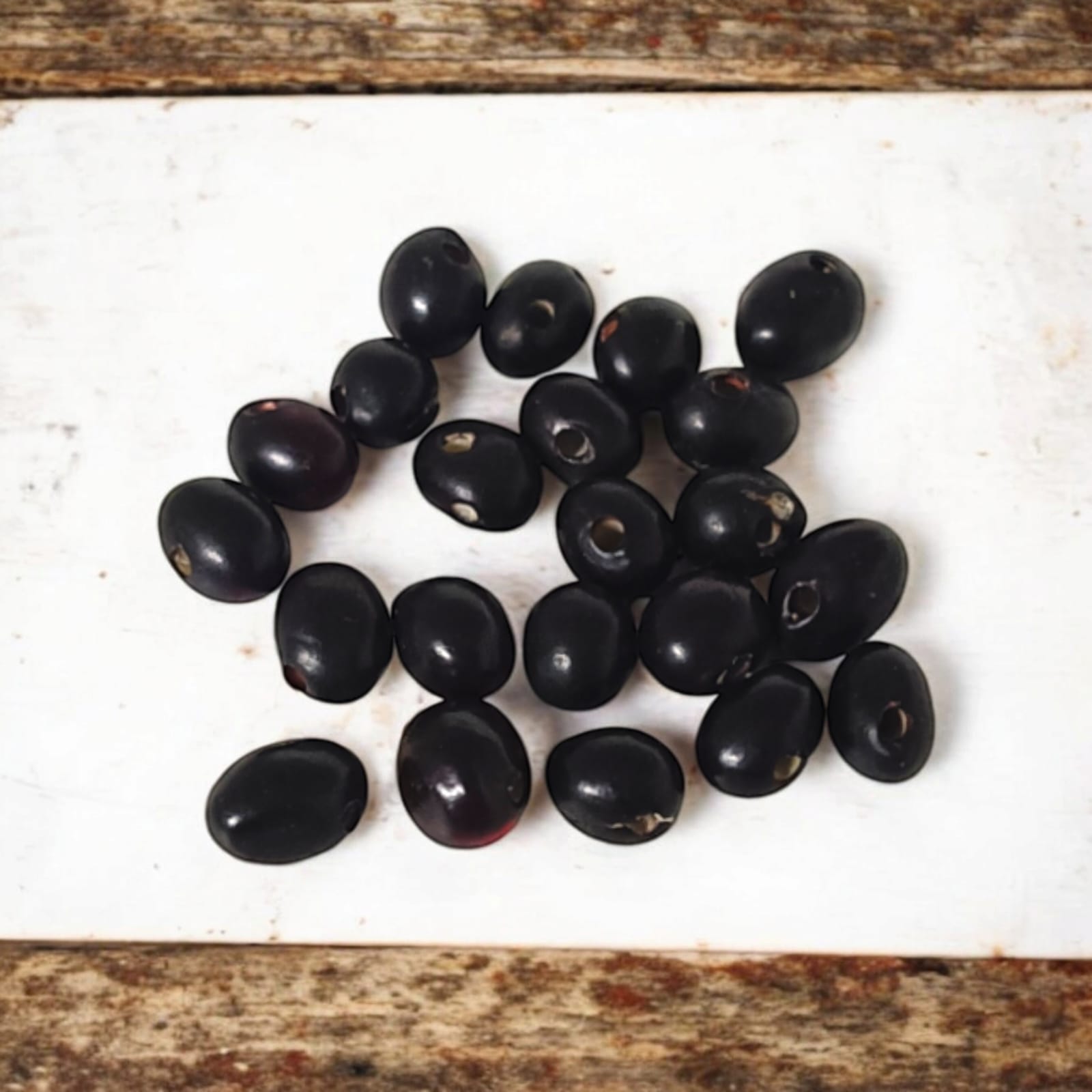 A set of 21 lab-certified Gunja seeds in red, white, and black, featuring loose beads ideal for spiritual use, crafting, or decoration.
