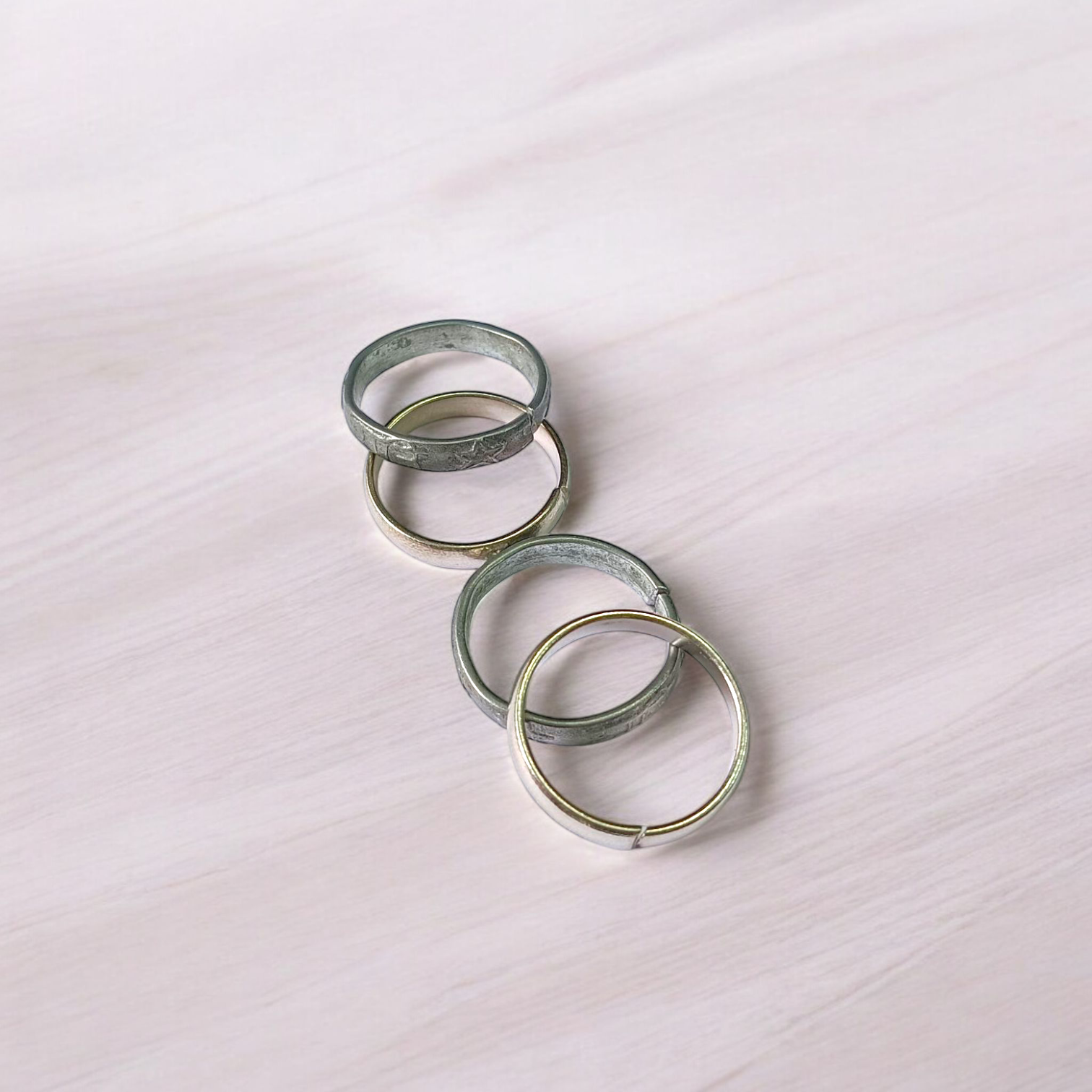 A set of four Ghode Ki Naal ka Challa rings made from black horse shoe nails, each ring designed to mitigate the negative effects of Saturn (Shani). The rings are shown in a close-up view to highlight their craftsmanship and material