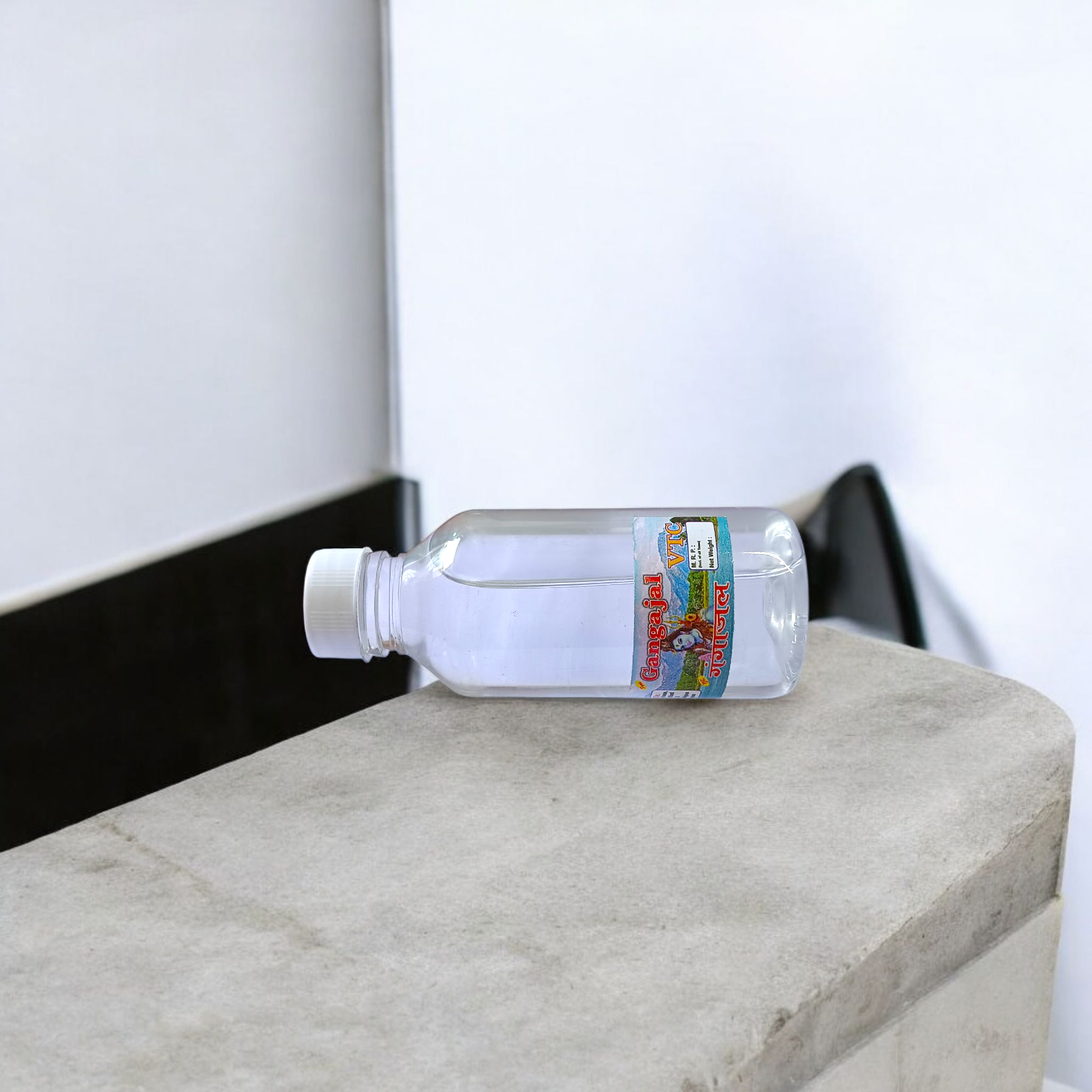 A set of two 100g bottles of Pure Gangajal Holy Water placed side by side, labeled for pooja and spiritual use