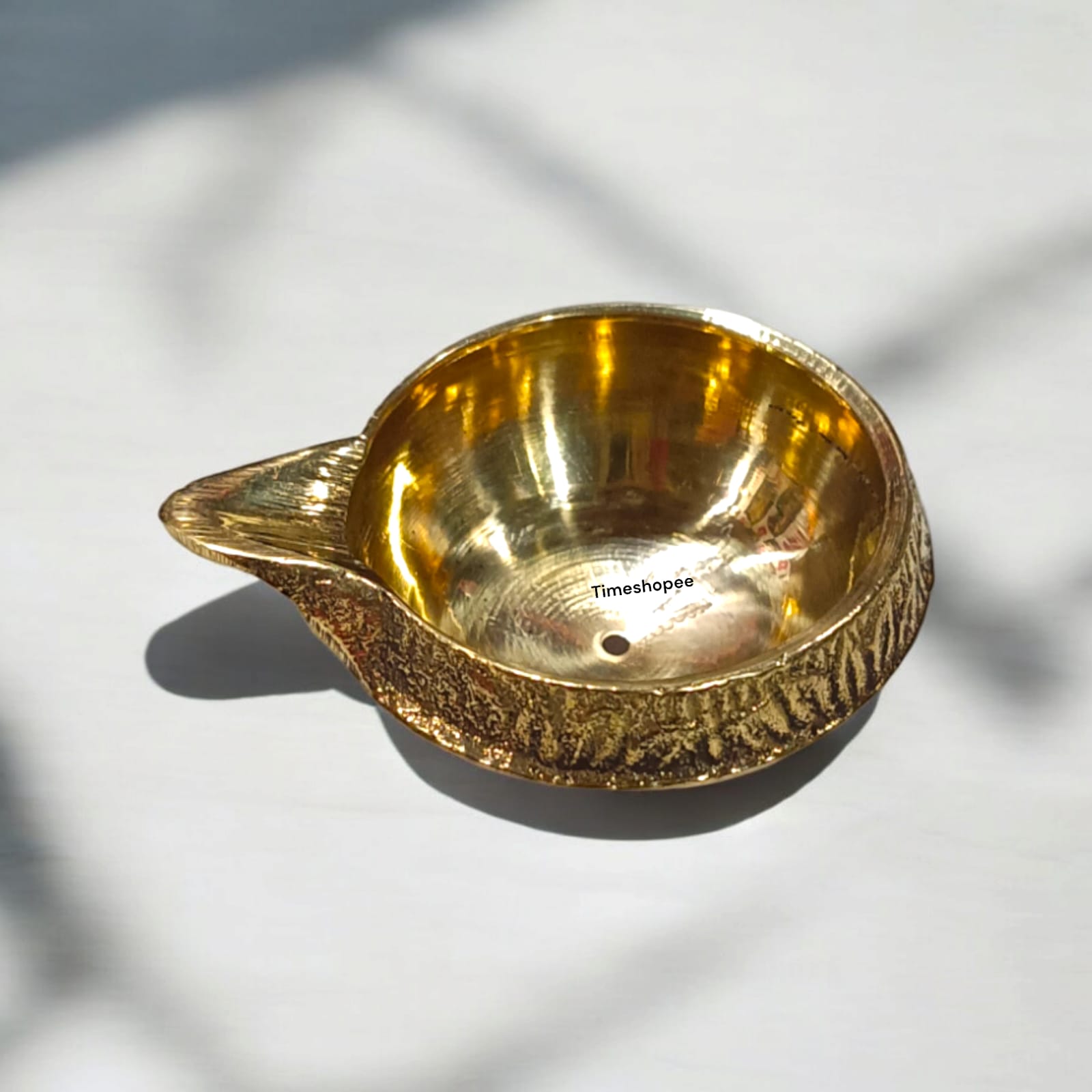 A small 2-inch brass oil lamp with a heavy base, perfect for pooja, festivals, and temple use, featuring a traditional design for stability during rituals.