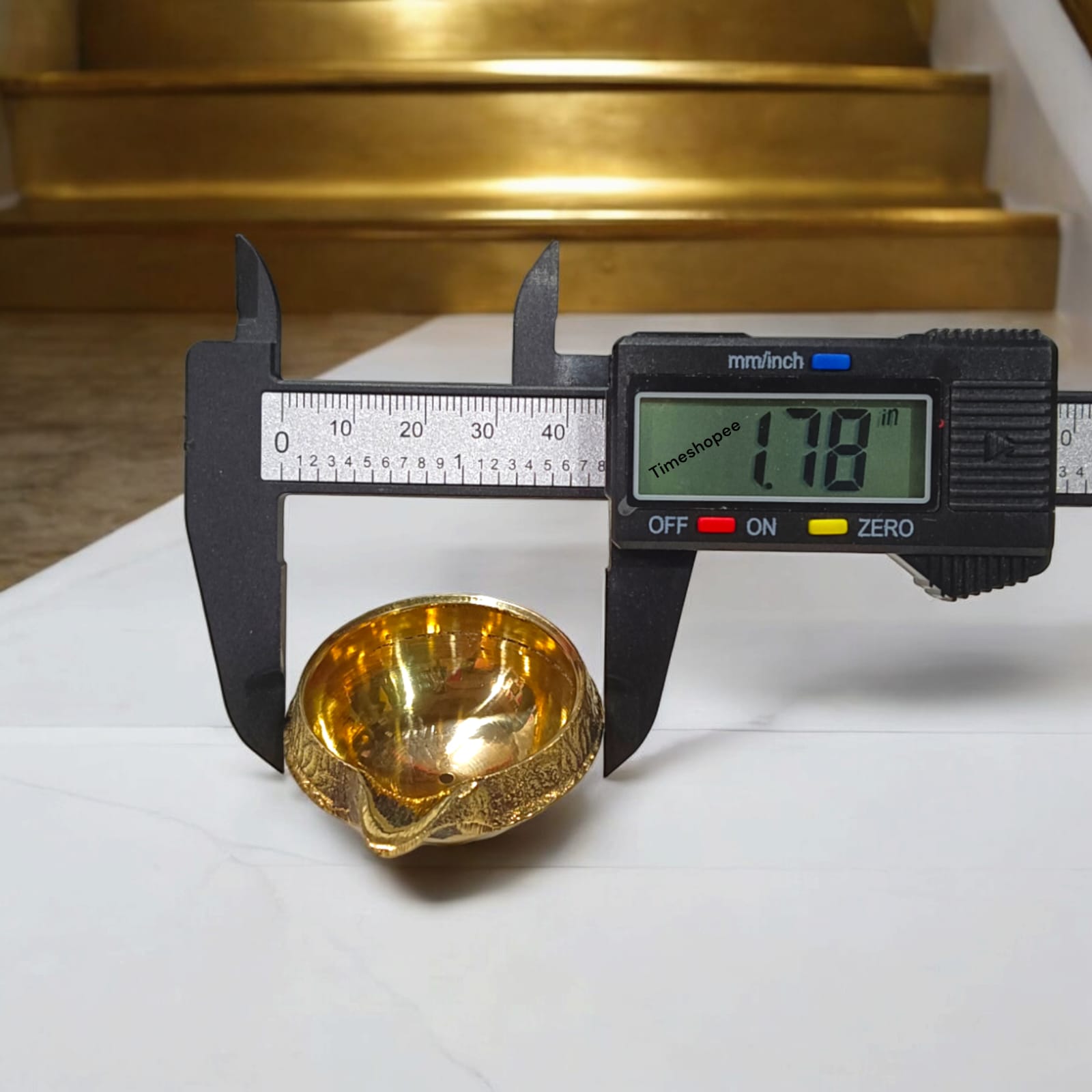 A small 2-inch brass oil lamp with a heavy base, perfect for pooja, festivals, and temple use, featuring a traditional design for stability during rituals.