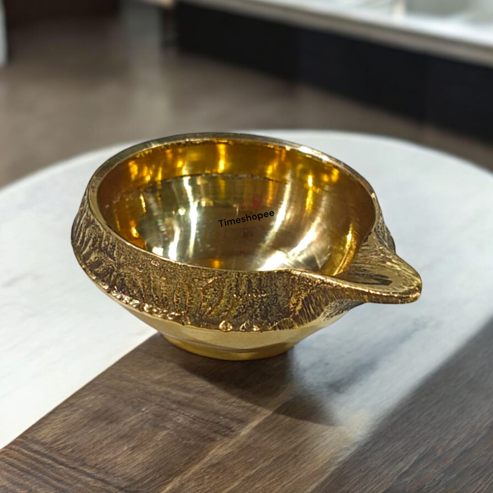 A small 2-inch brass oil lamp with a heavy base, perfect for pooja, festivals, and temple use, featuring a traditional design for stability during rituals.