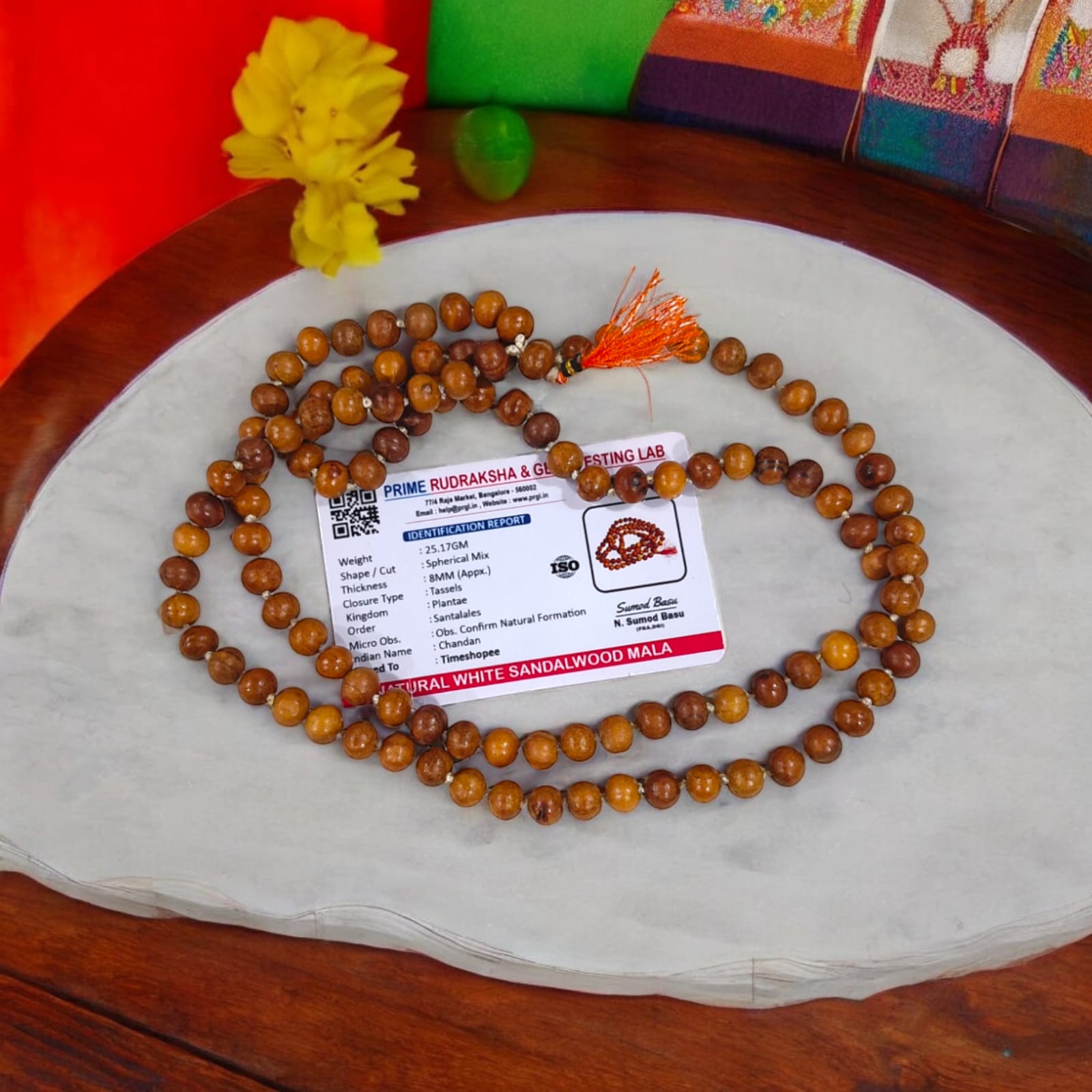 A traditional White Sandalwood Mala (Safed Chandan Mala) made with 108+1 beads, displayed with a sacred backdrop