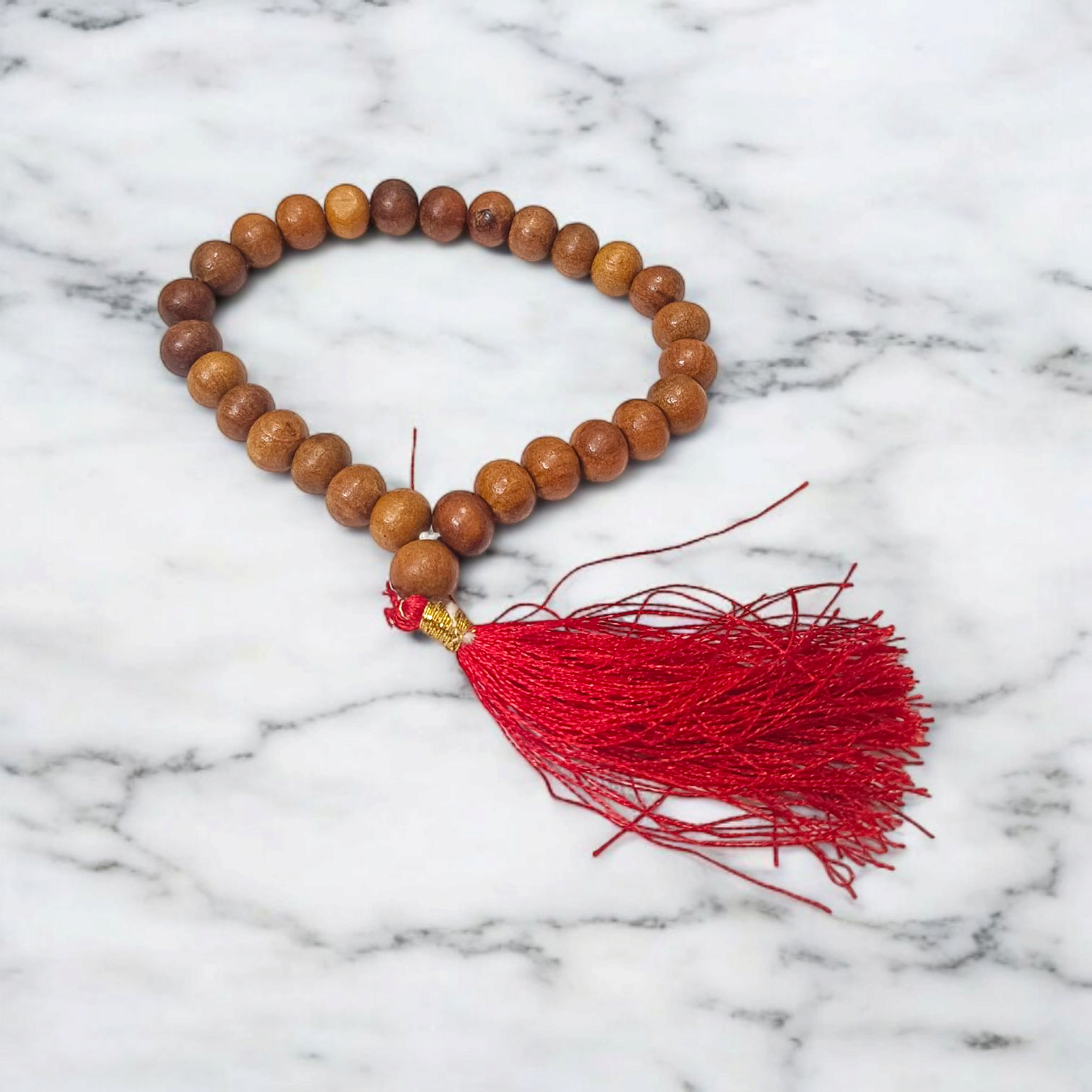 A traditional White Sandalwood Mala (Safed Chandan Mala) made with 108+1 beads, displayed with a sacred backdrop