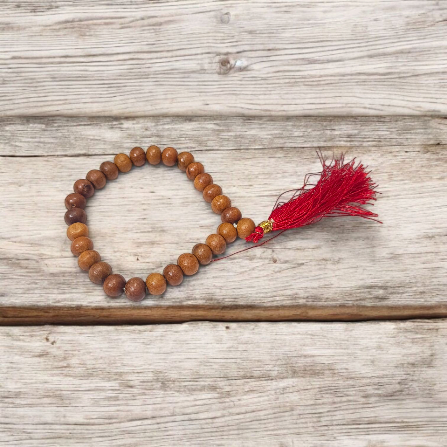 A traditional White Sandalwood Mala (Safed Chandan Mala) made with 108+1 beads, displayed with a sacred backdrop