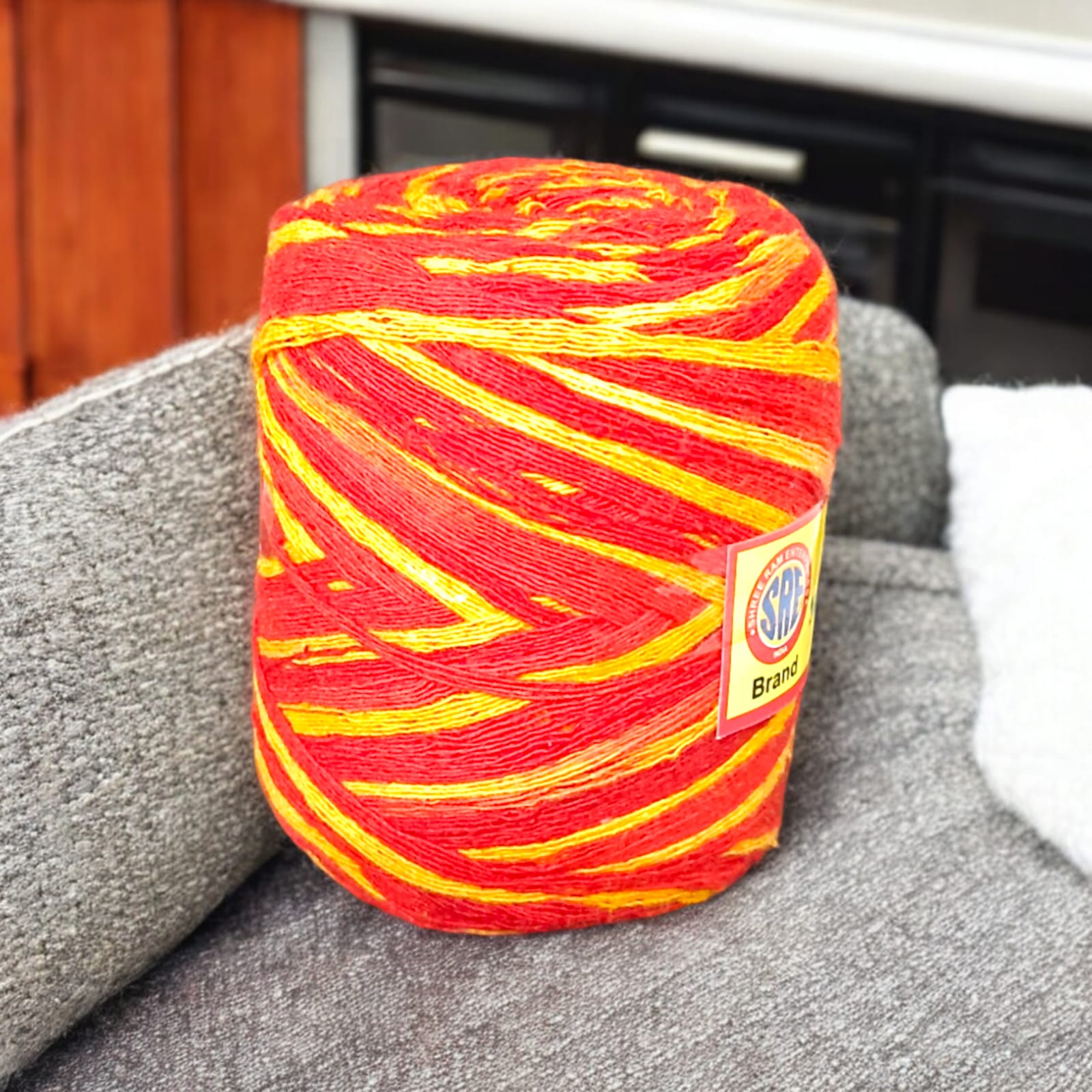 A vibrant red and yellow Moli Kalawa thread made of organic cotton, neatly coiled with extra-large length, perfect for Hindu rituals and worship ceremonies.
