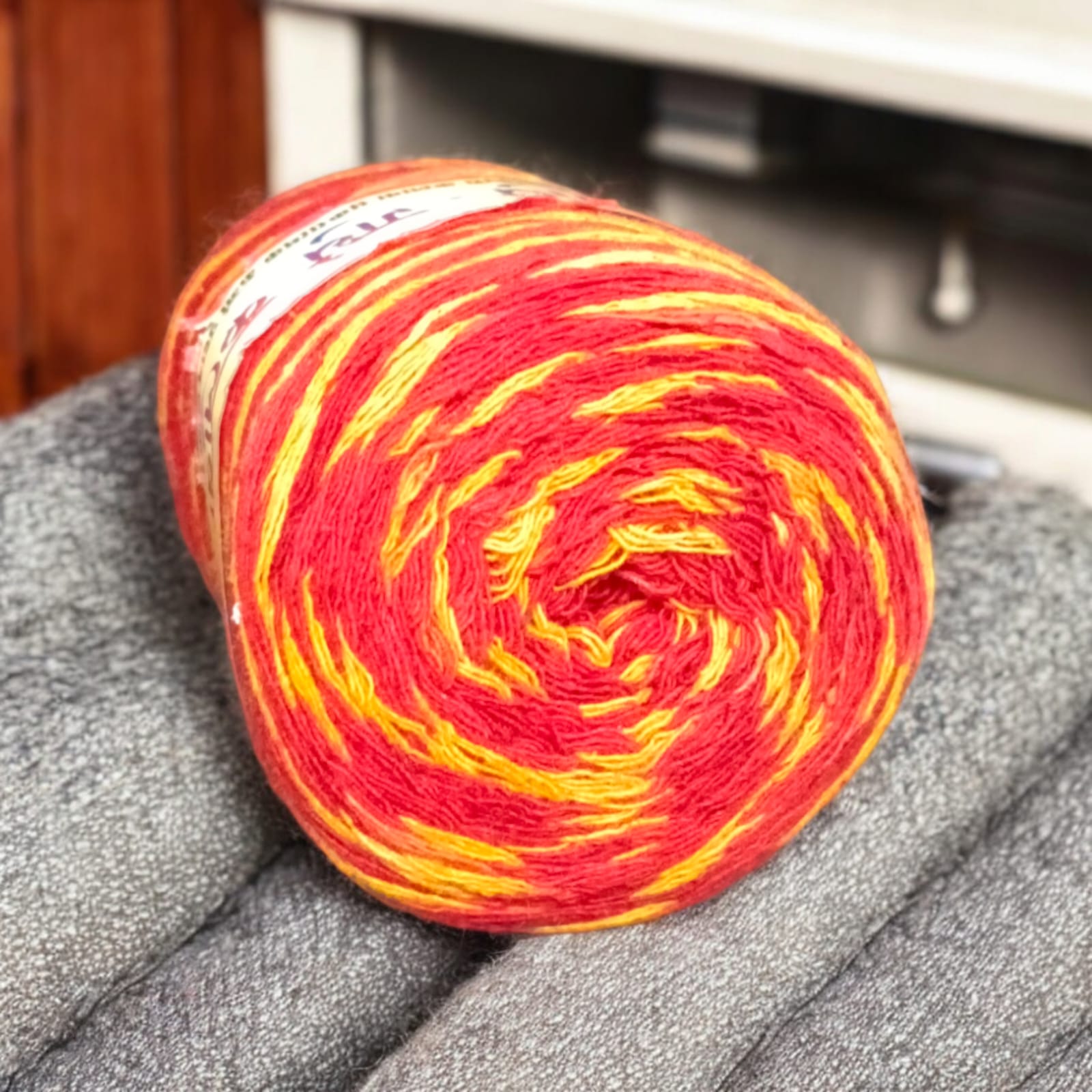 A vibrant red and yellow Moli Kalawa thread made of organic cotton, neatly coiled with extra-large length, perfect for Hindu rituals and worship ceremonies.