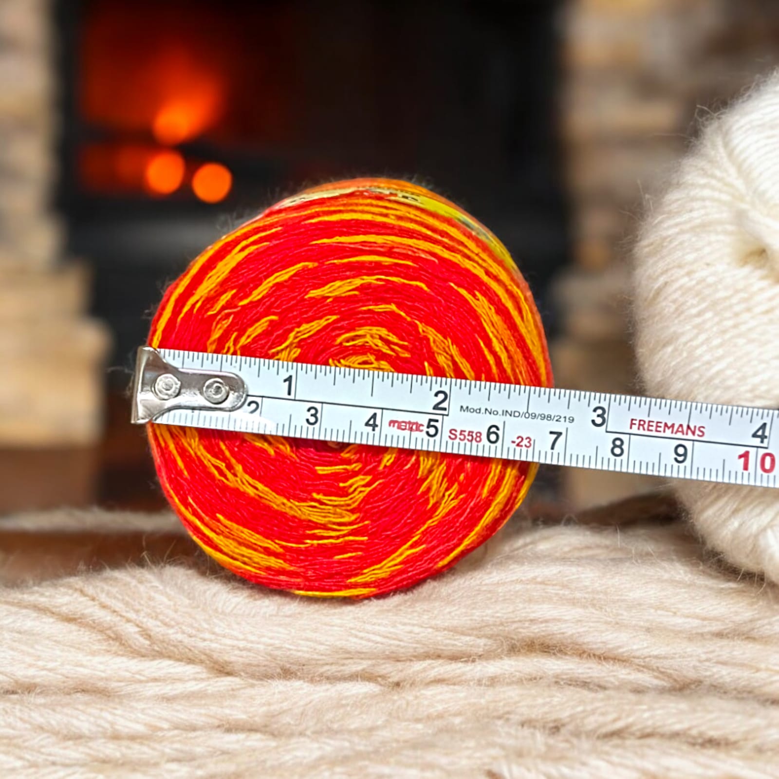 A vibrant red and yellow Moli Kalawa thread made of organic cotton, neatly coiled with extra-large length, perfect for Hindu rituals and worship ceremonies.